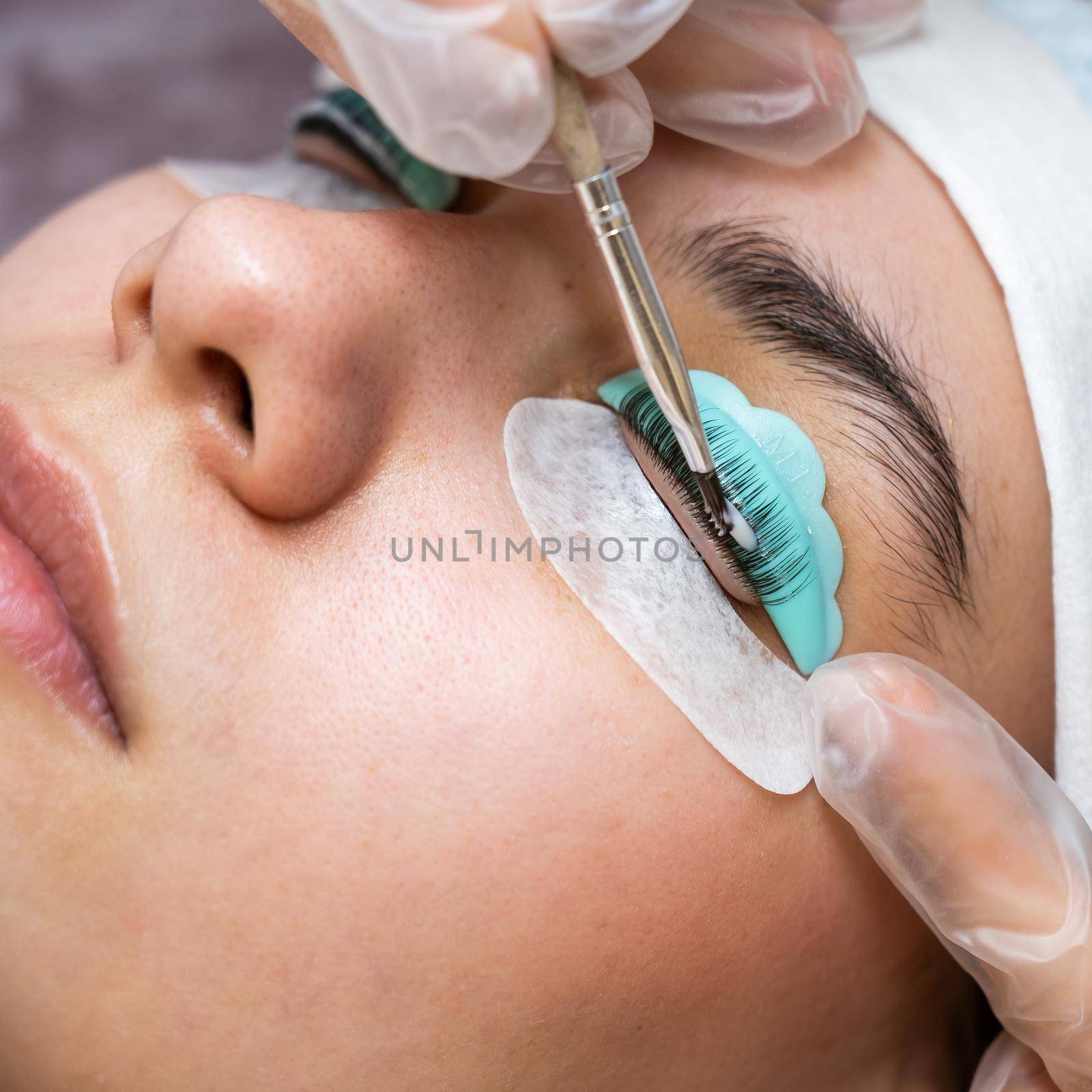 Close-up portrait of a woman on eyelash lamination procedure. by mrwed54