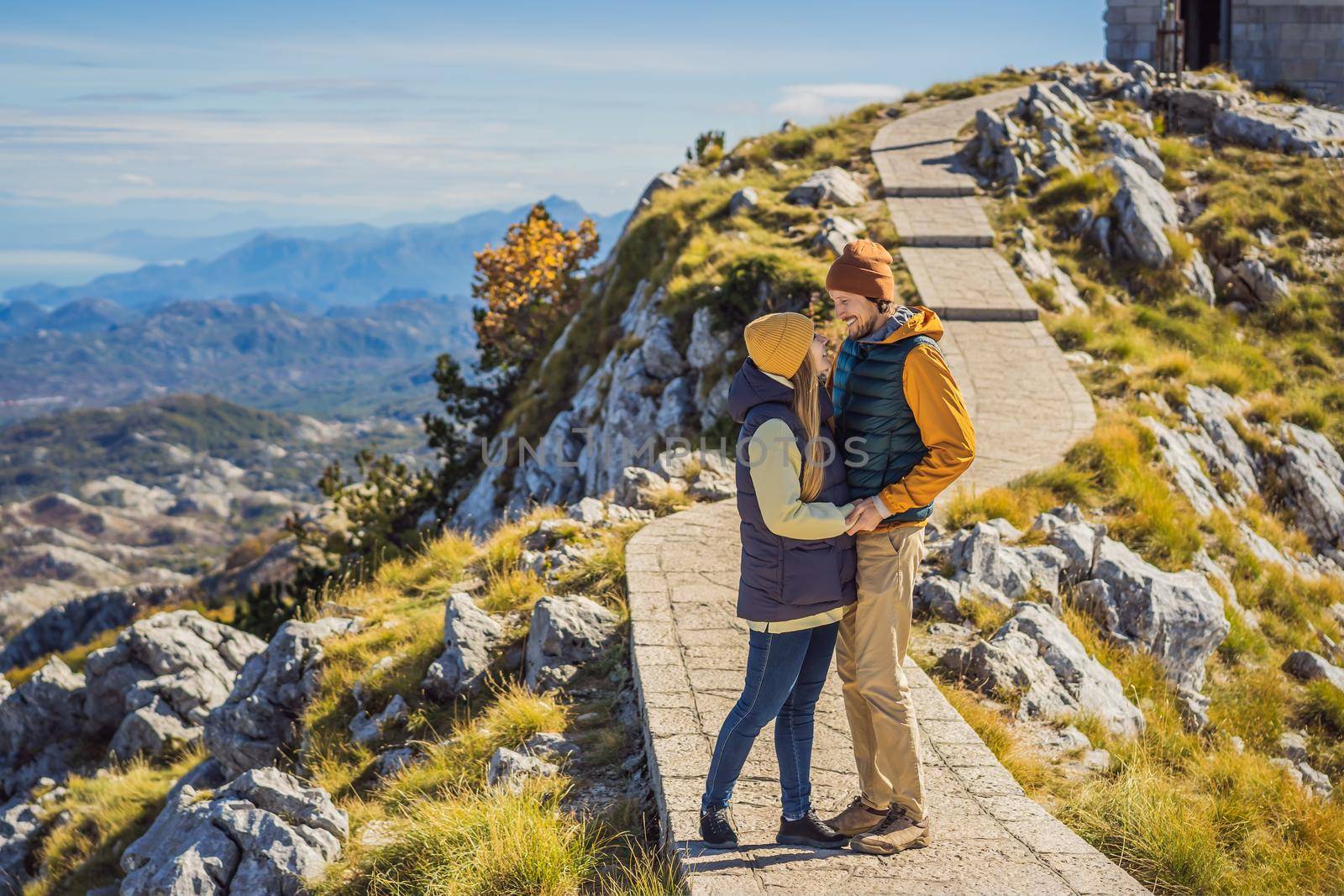 Couple man and woman tourists in mountain landscape at national park Lovcen, Montenegro. Travel to Montenegro concept by galitskaya