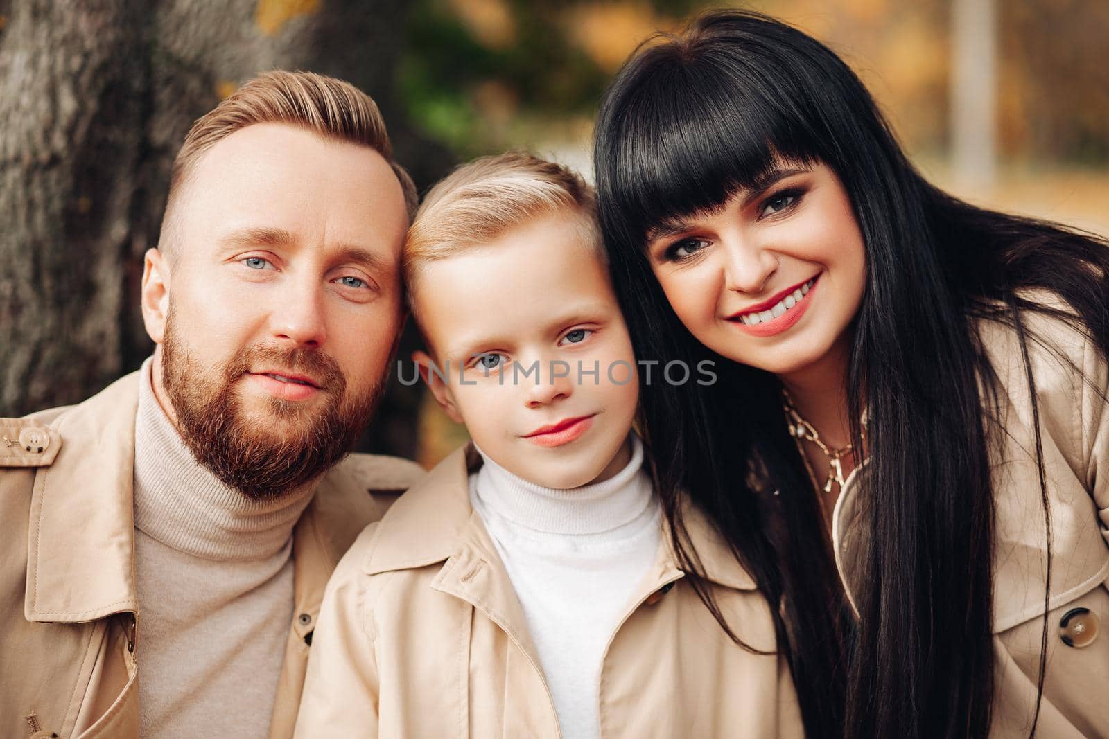 Happy family, portrait. Dad, Mom, Son smile, look at the camera. by StudioLucky