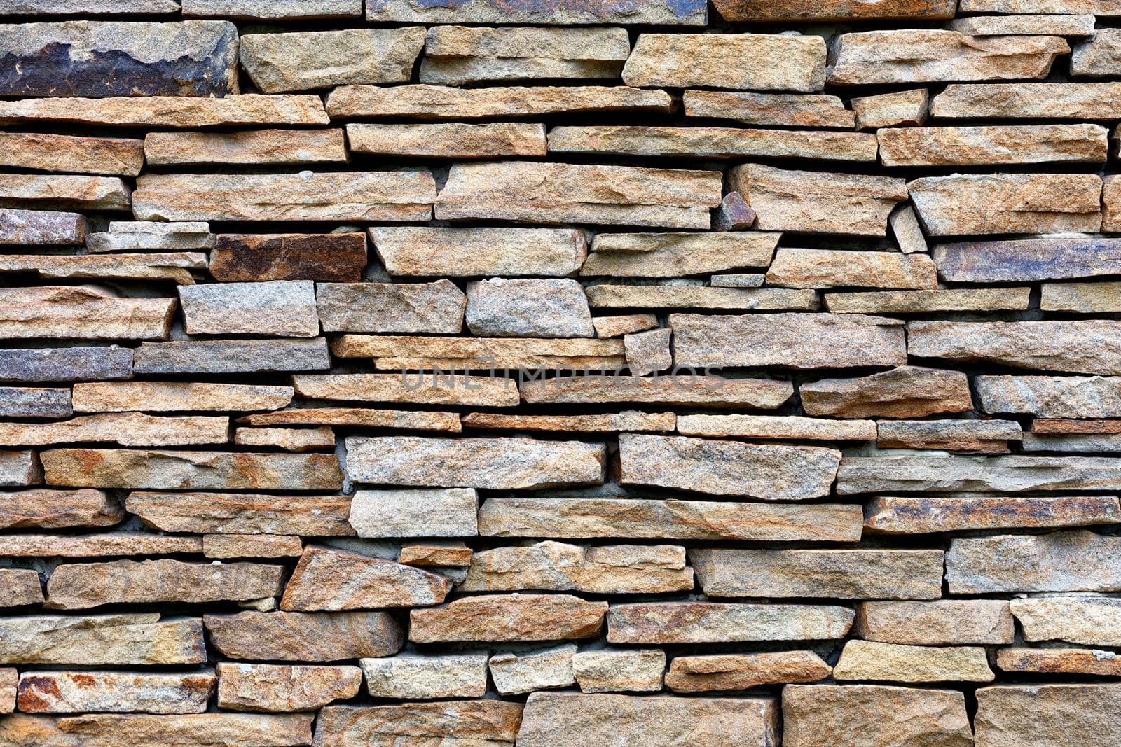 Sandstone stone wall mosaic, texture and background. by Sergii