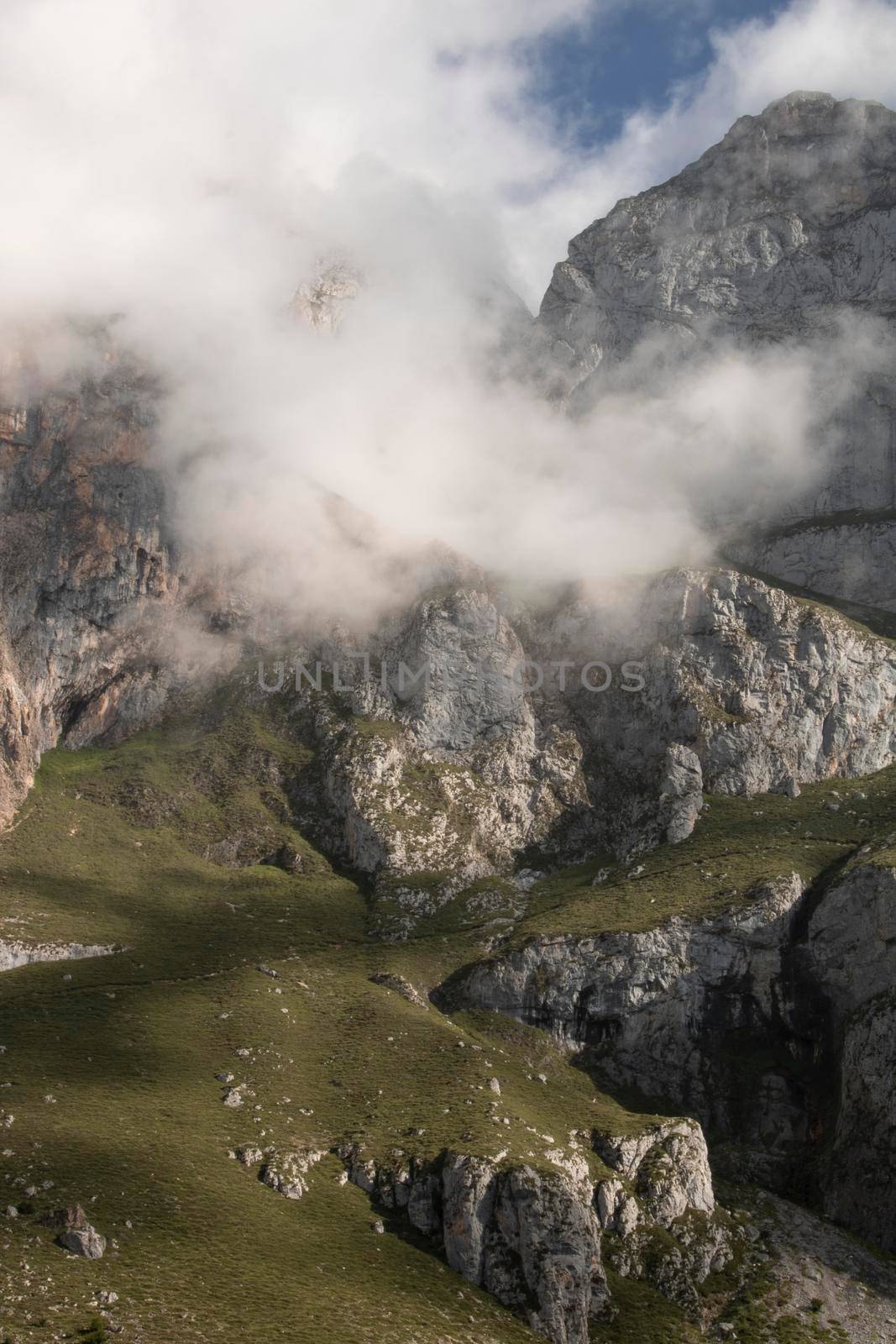 Foggy landscape showing a rocky mountain in Fuente De in Picos de Europa in Spain