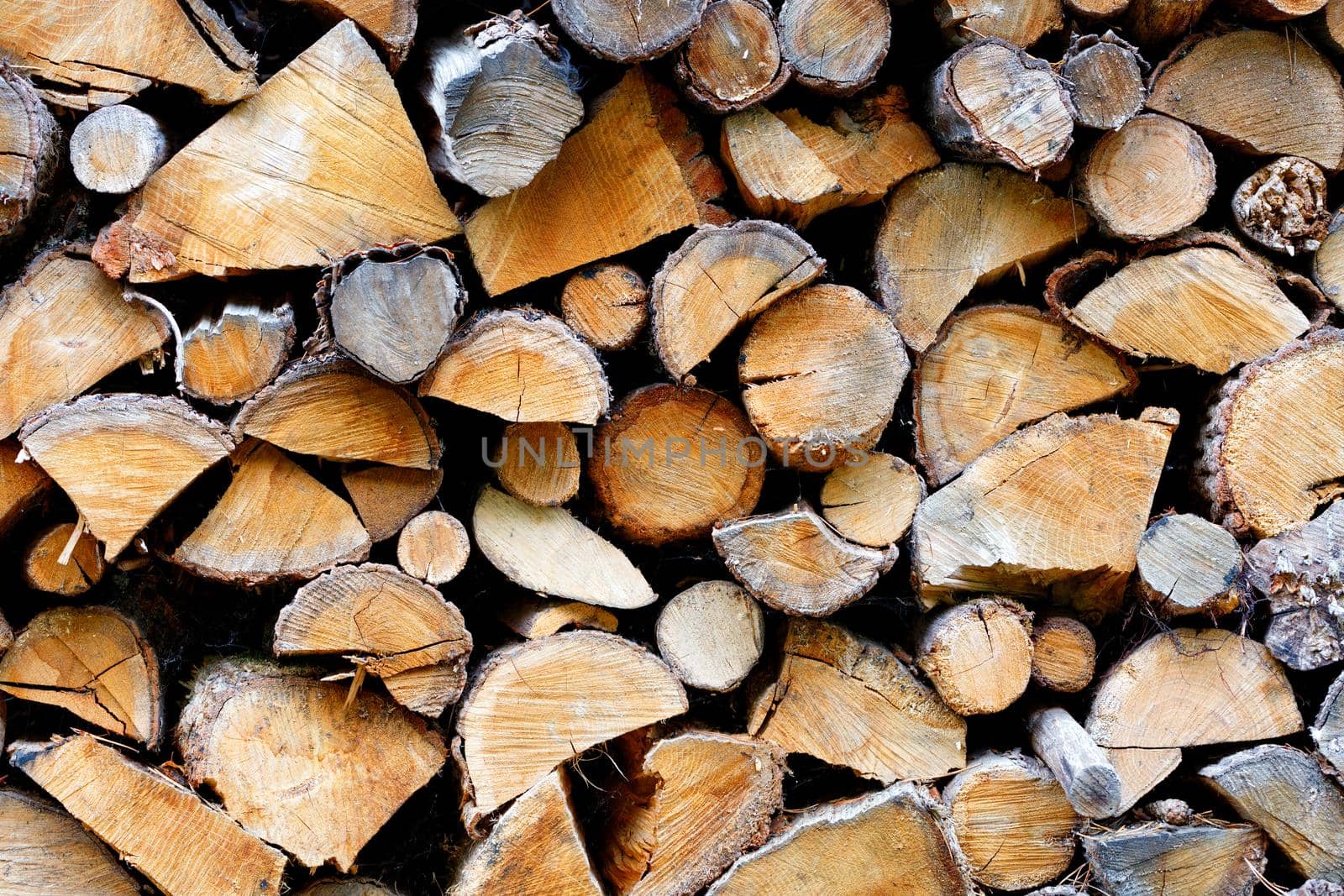 The texture of a stack of chopped densely folded firewood, close-up. by Sergii
