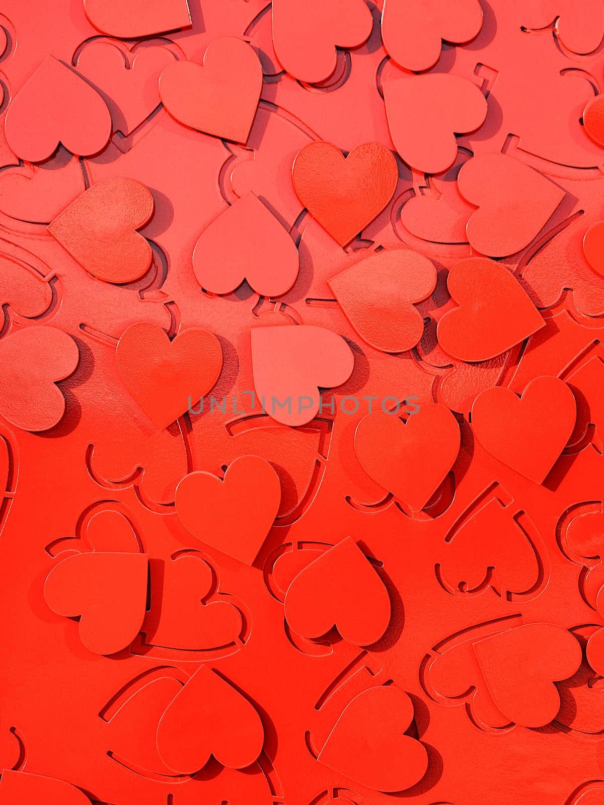 Red metal hearts setting as a symbol of love. by Sergii
