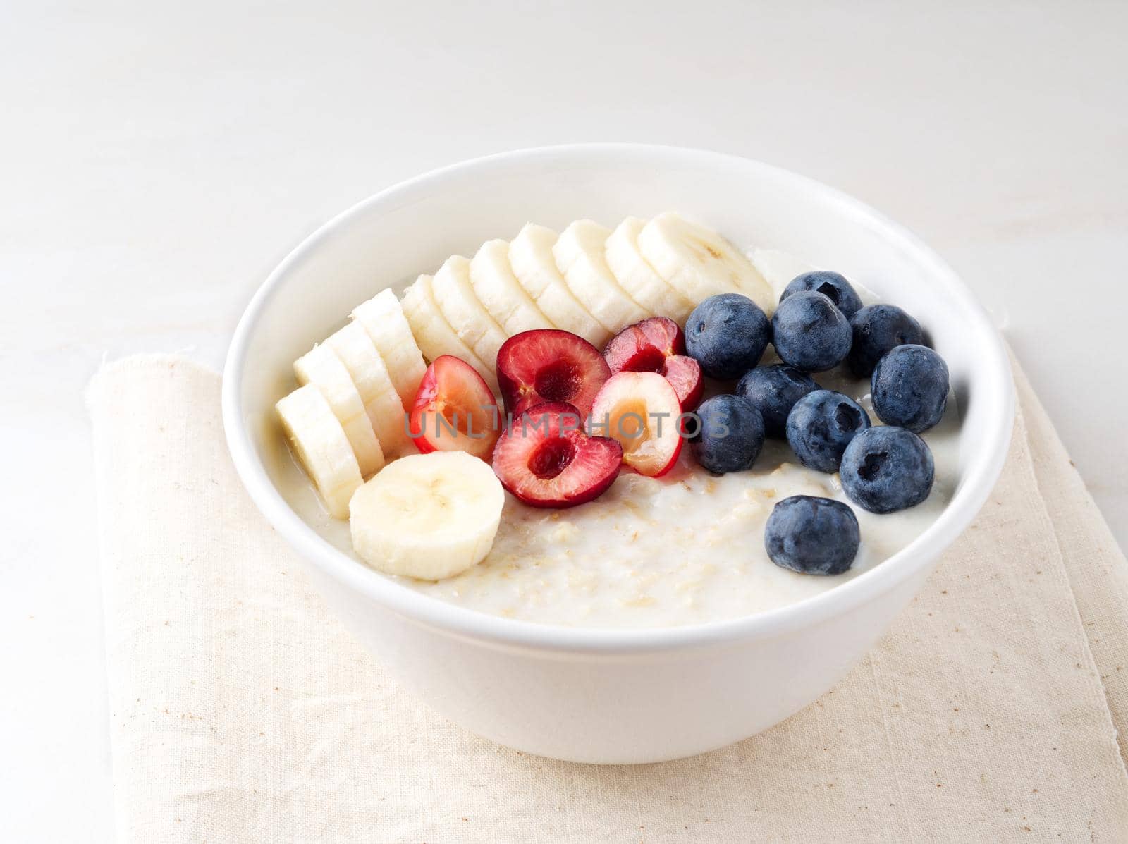 Large bowl of tasty and healthy oatmeal with fruits and berry for Breakfast, morning meal by NataBene