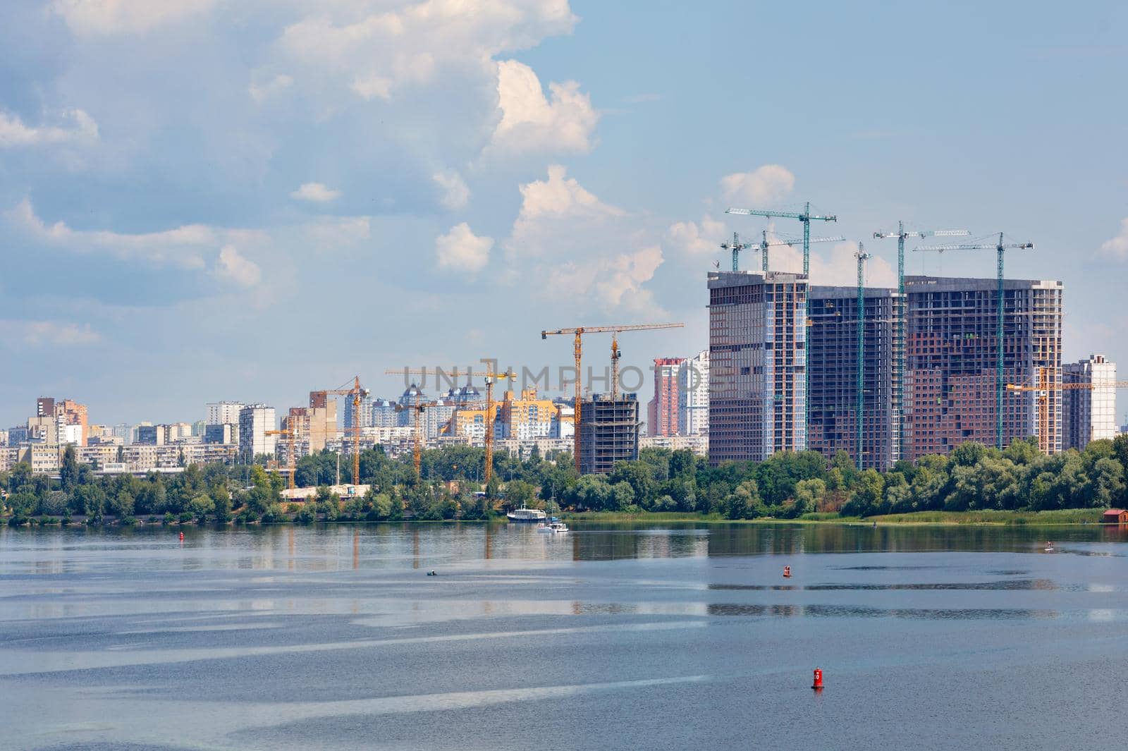 Cityscape, new residential buildings are being built on the banks of the Dnipro River. by Sergii