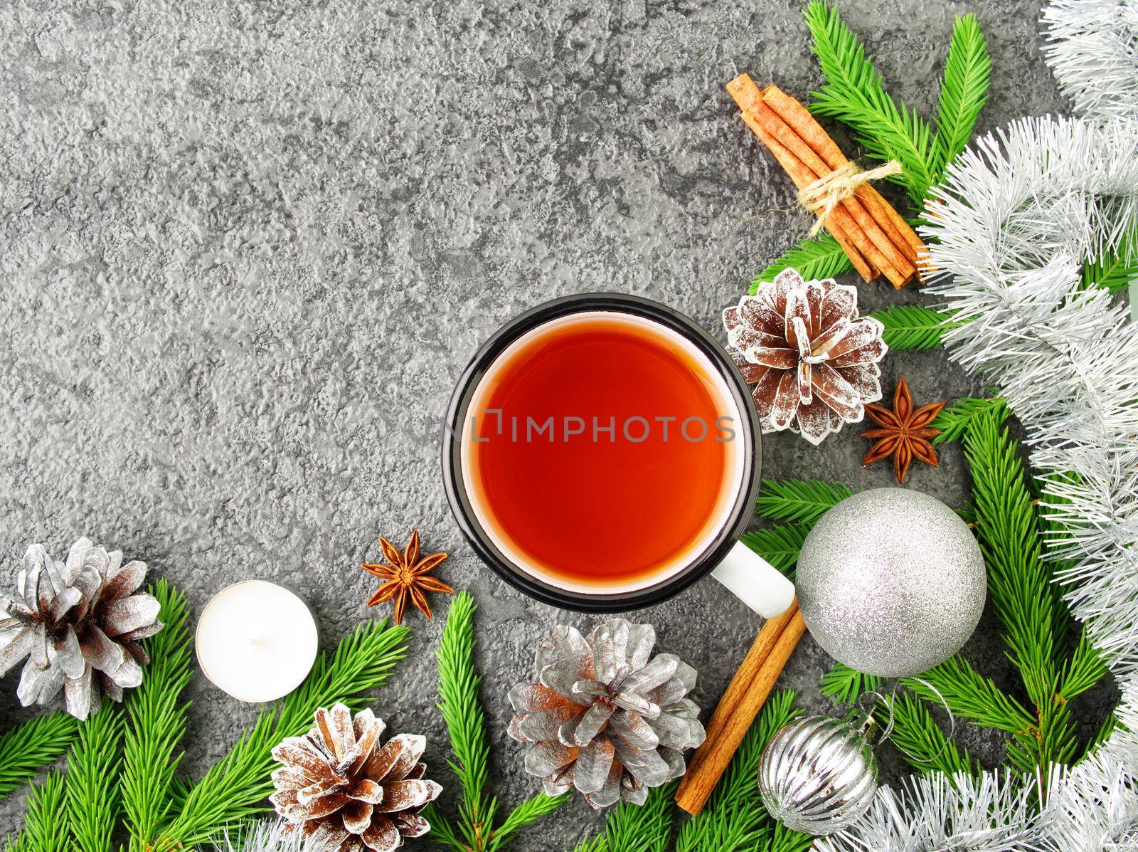 Christmas and Happy New Year background with tea. Top view, copy space. Fir branches, a silver concrete