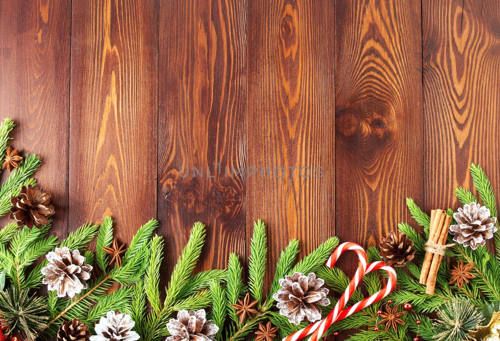 Christmas and Happy New Year dark brown background. Top view, copy space, a wooden rustic table, fir branches