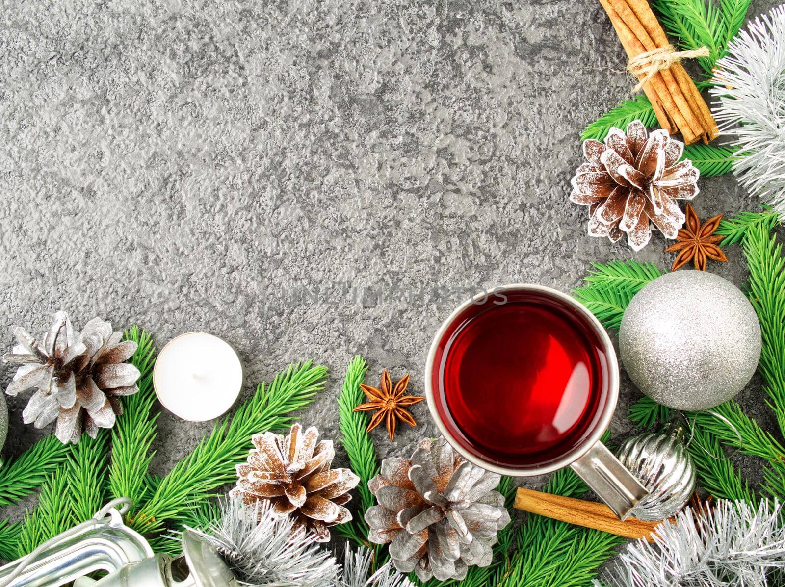 Christmas and Happy New Year background with tea. Top view, copy space, a military stile. Fir branches, silver concrete