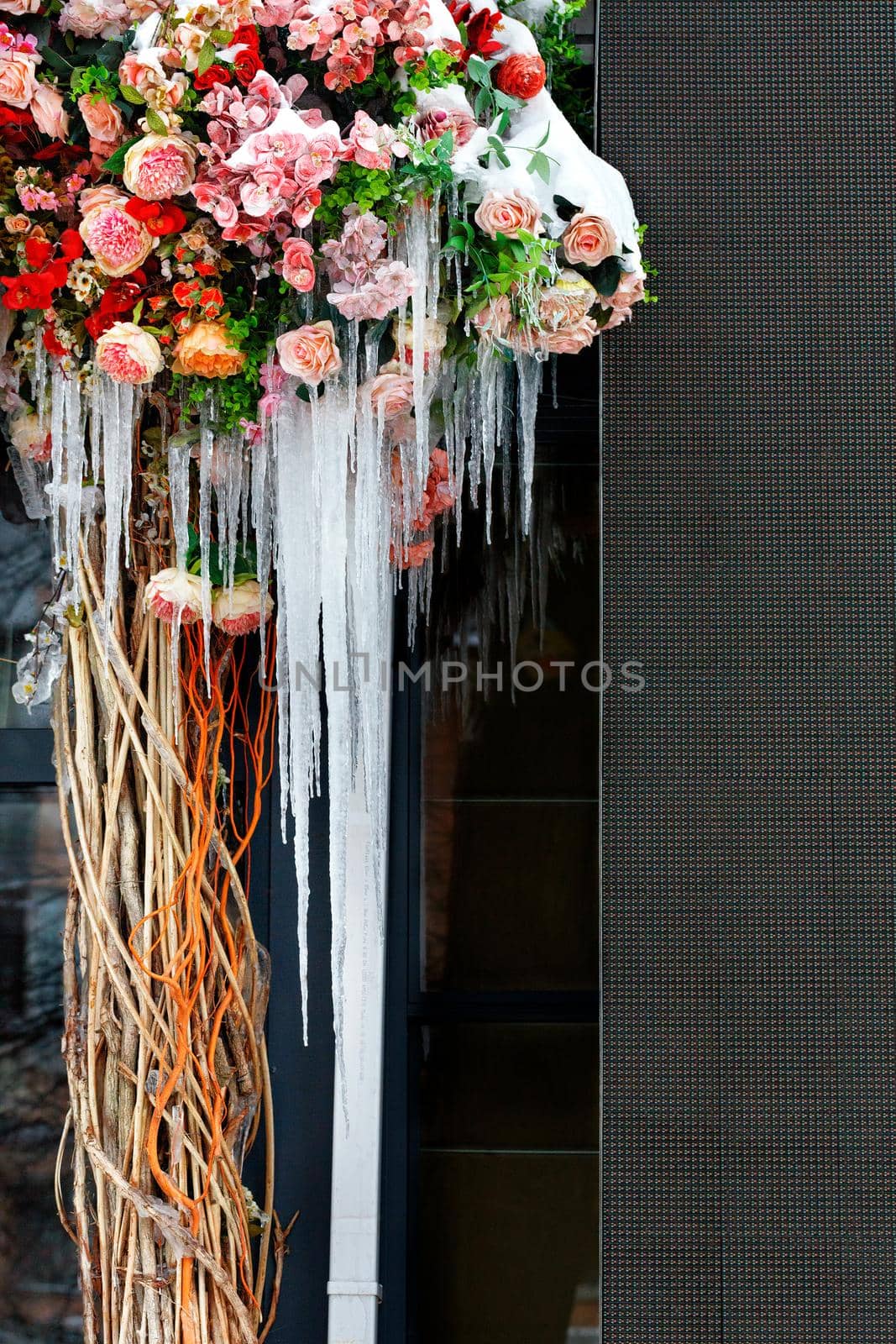 A bouquet of snow-covered flowers with ice icicles on the terrace. by Sergii