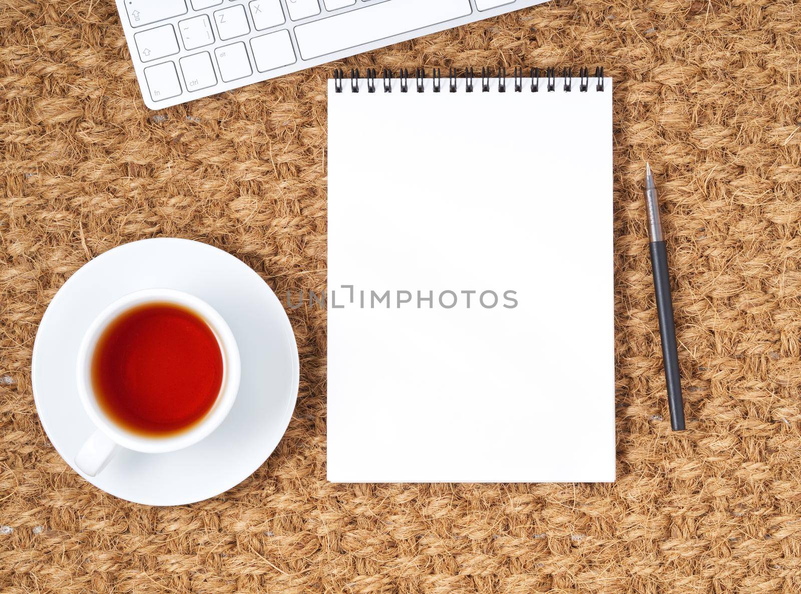 Workplace with laptop and blank notepad on mat. Top view. Flat lay. by NataBene