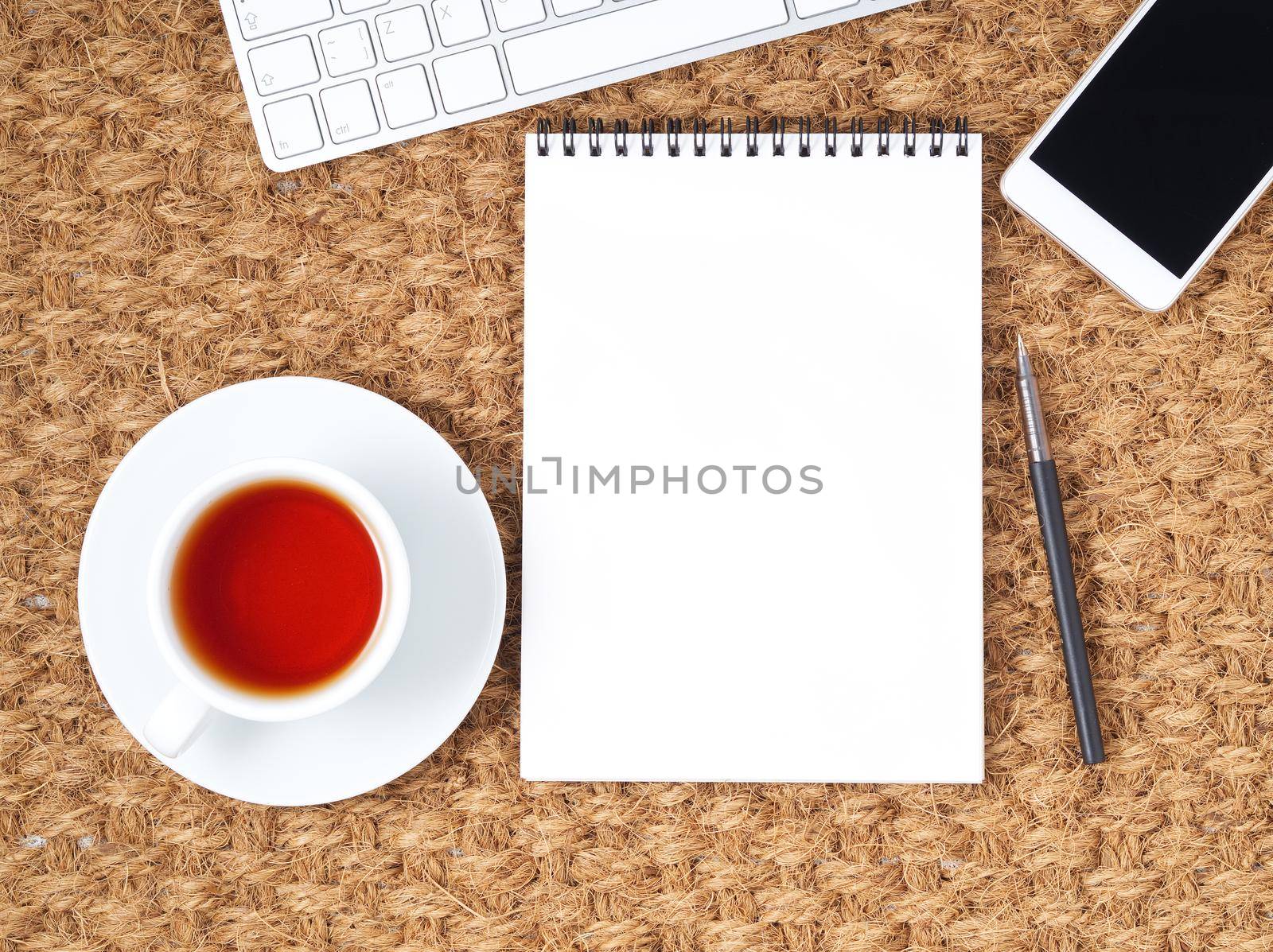 Workplace with laptop and blank notepad on mat. Top view. Flat lay. Freelance desktop, warm climate by NataBene