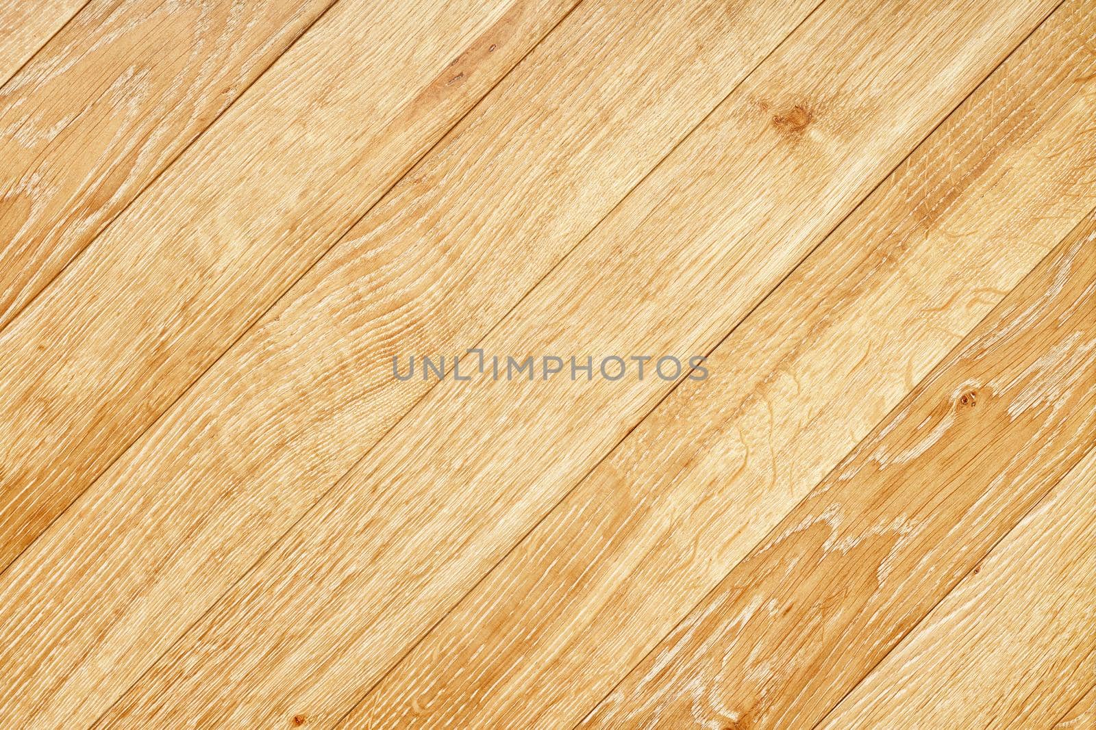 A beautiful pattern of light oak wood in the form of a smooth wooden surface with diagonal grain lines.
