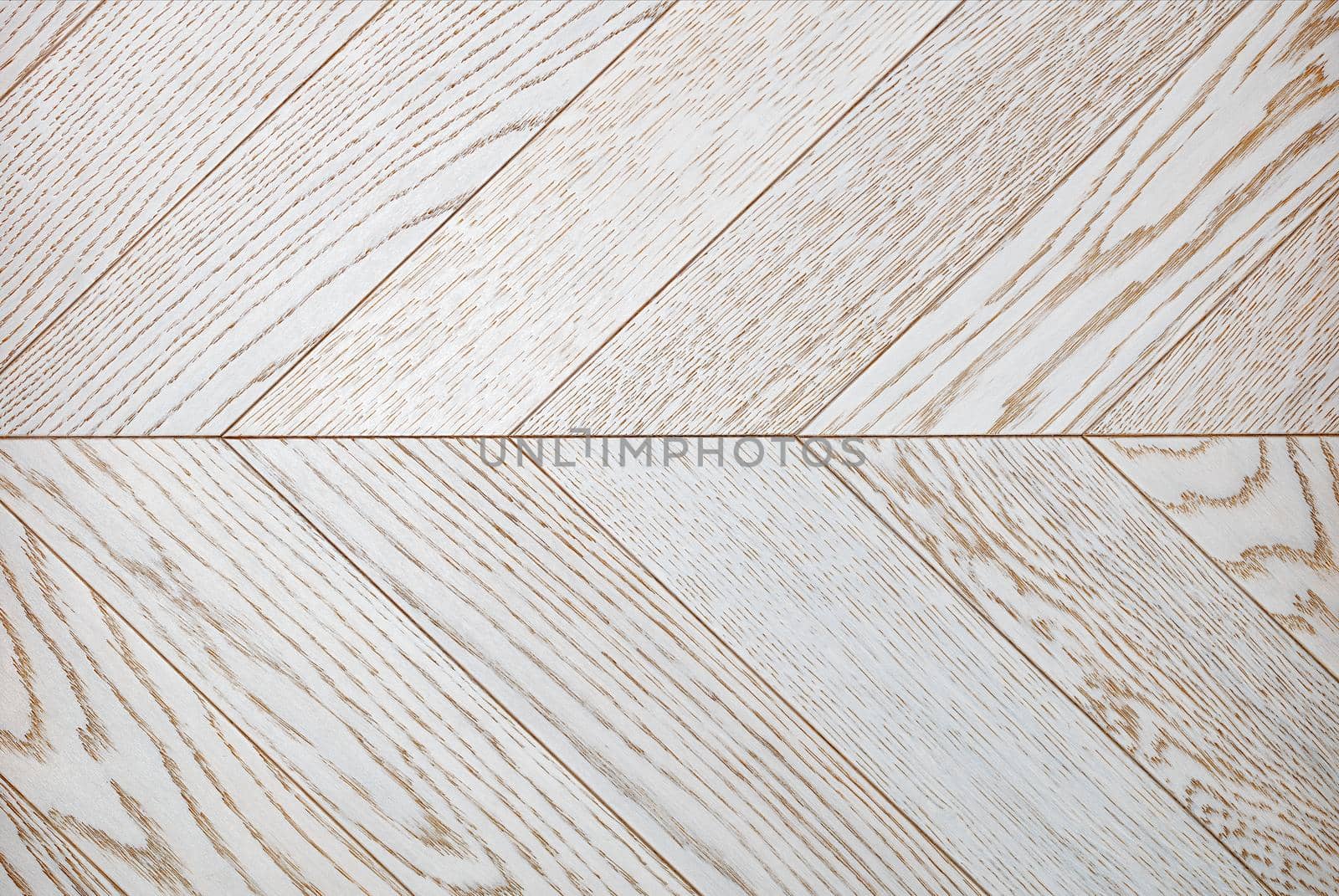 Wooden light planks with a bright texture in white, arranged symmetrically opposite each other in a herringbone shape.