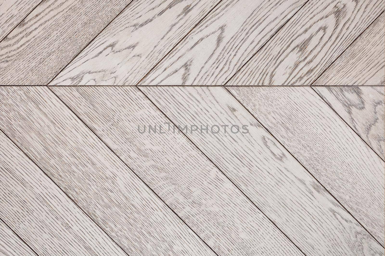 Wood planks with a vibrant gray texture are neatly stacked side by side. by Sergii