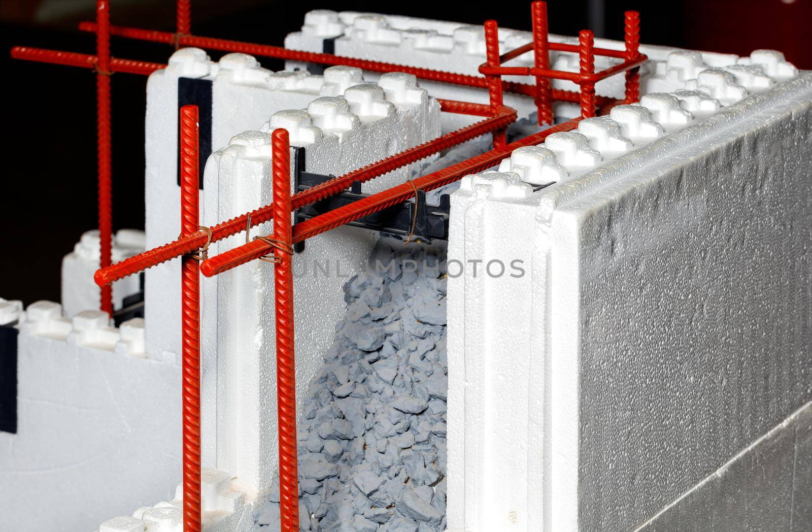 The diagram shows the use of metal reinforcement in conjunction with concrete in construction when laying and erecting walls of a building made of polystyrene and polyurethane foam. Concept and new technologies in the construction industry.