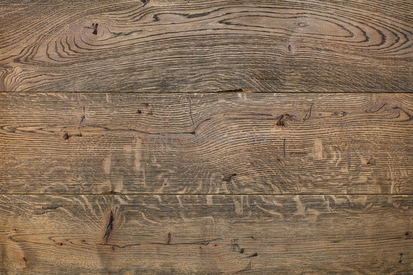 Old, cracked wooden background of horizontal planks and the dark brown texture of an old dark oak tree with cracks and knots.