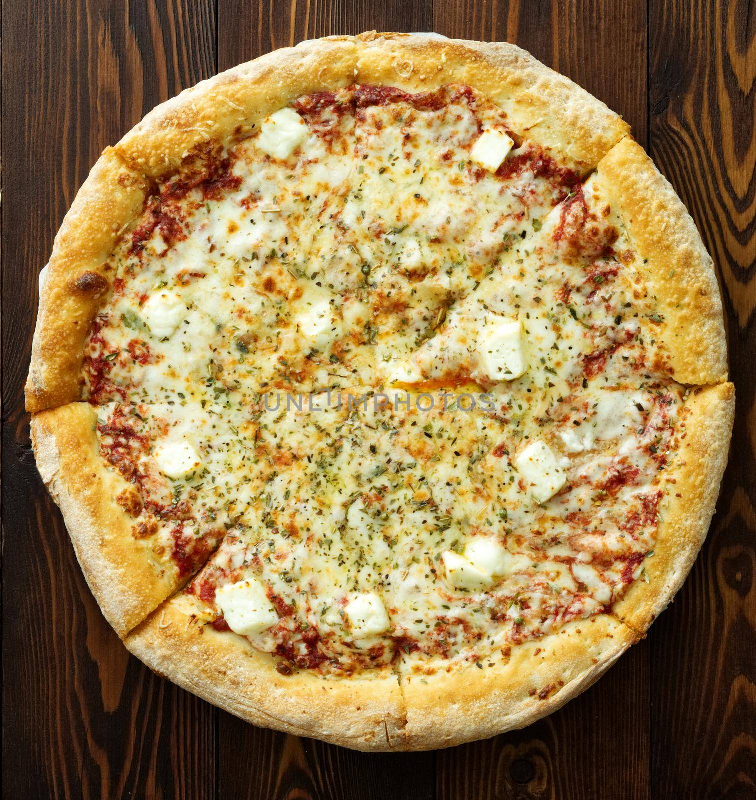 Four cheese pizza with a Dor-blue, Parmesan, feta, oregano, mozzarella, tomato sauce, top view