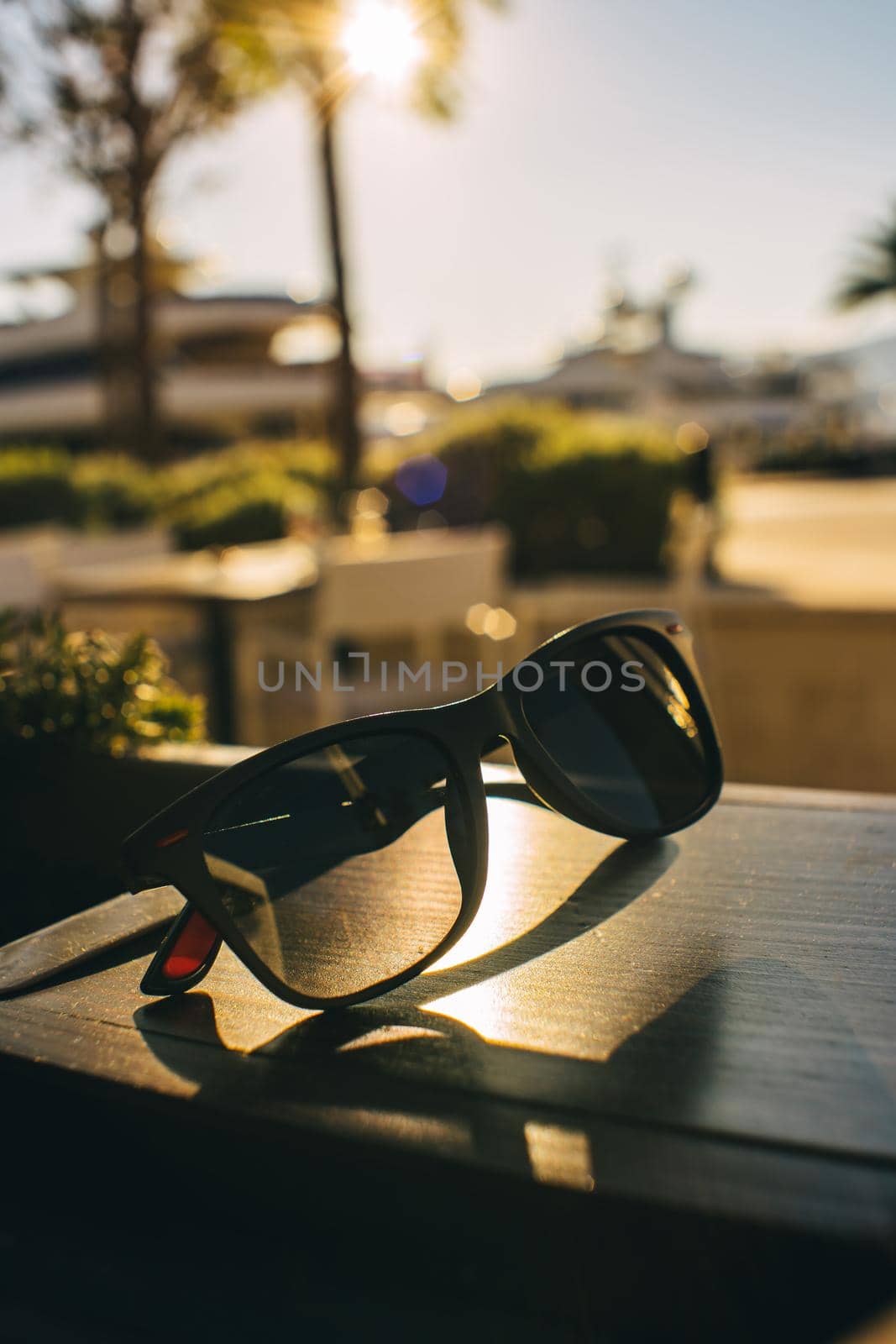 Sunglasses on wood table in the sun wallpaper on the desktop. High quality photo