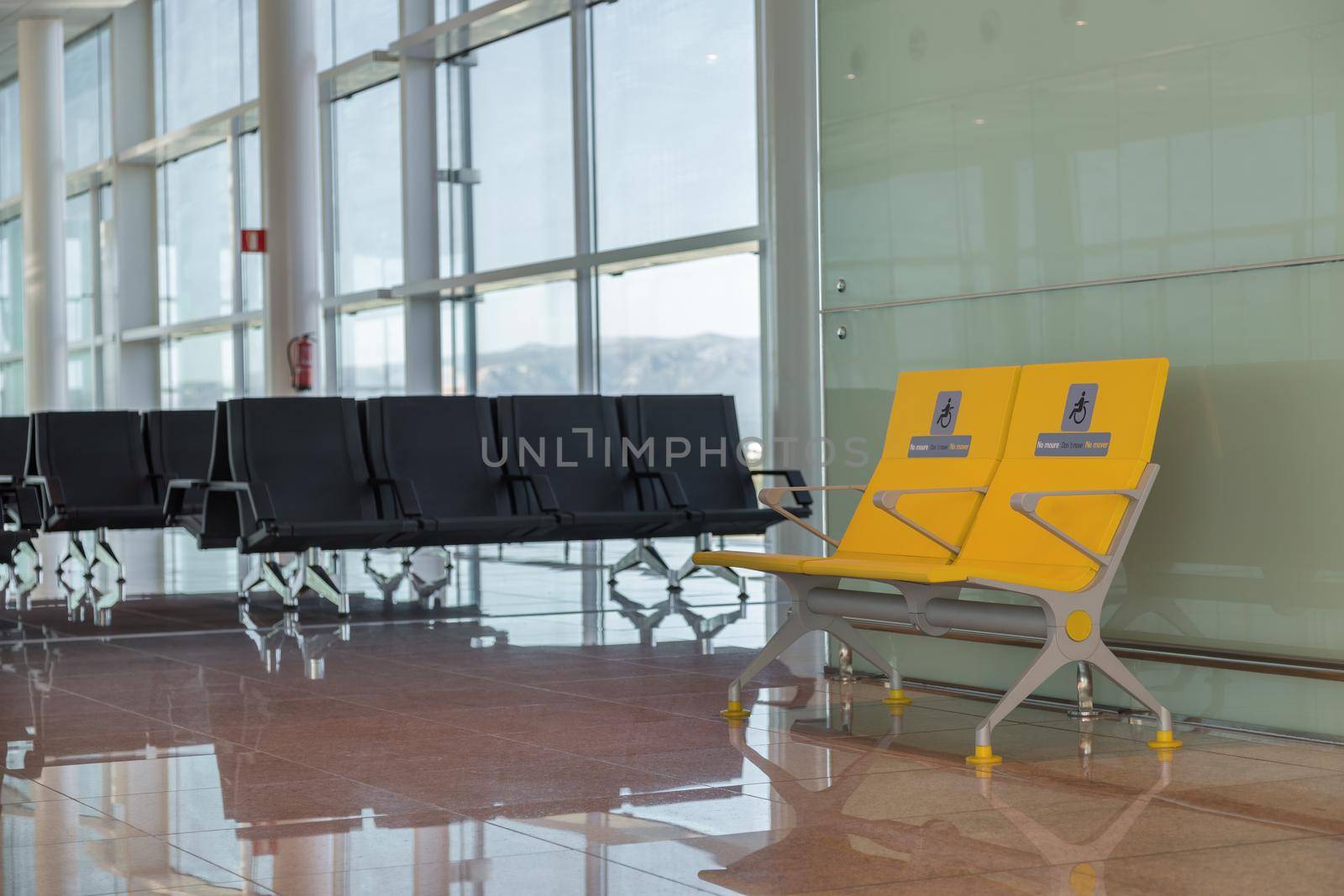 Empty priority seats in international airport reserved for disabled people. Normal and yellow disabled seats in the waiting area before boarding. by apavlin