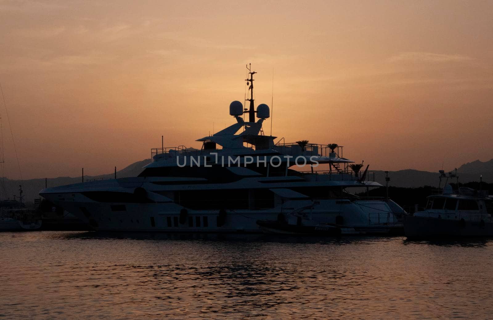 Panoramic view of marina di Olbia port and yacht marina at sunset by massimocampanari