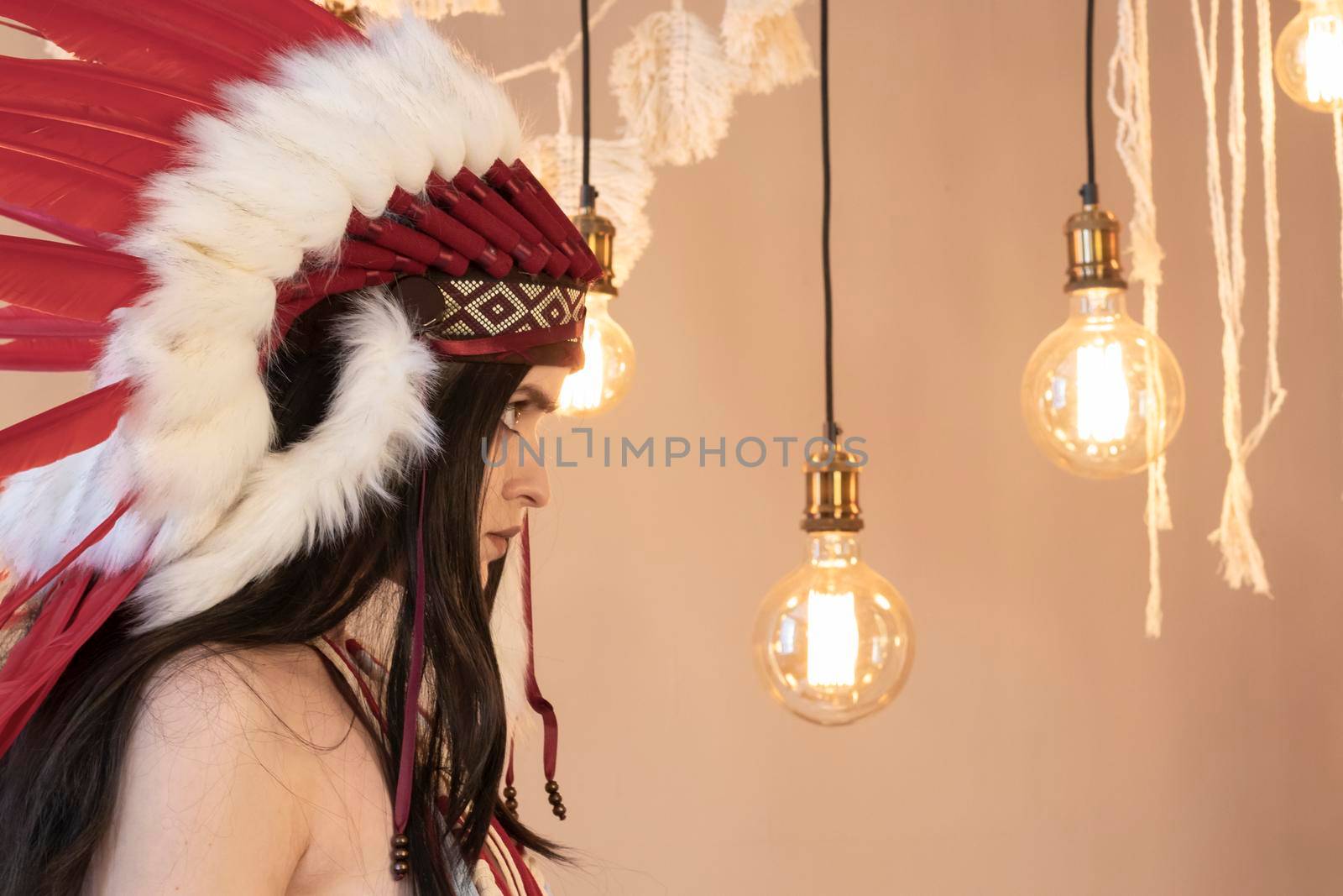 Native American Indian woman. Fashionable young lady in Indian roach. Boho style dress.