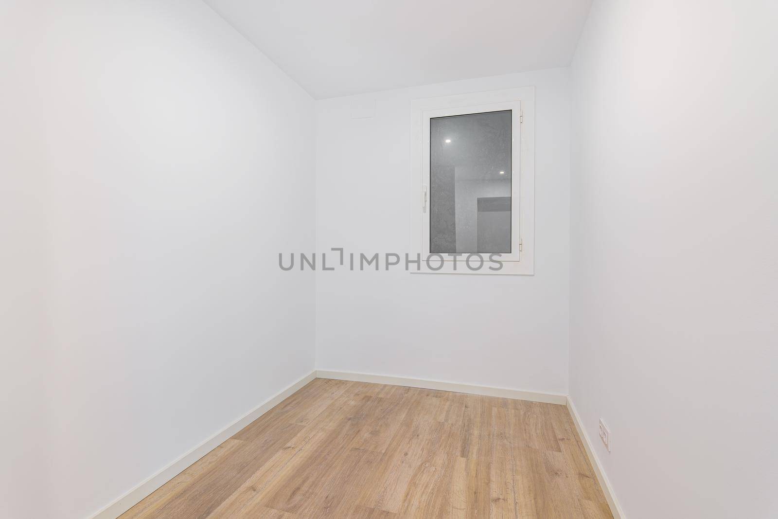 Empty room after renovation with white walls and dust window without natural light. Typical apartment in Barcelona by apavlin
