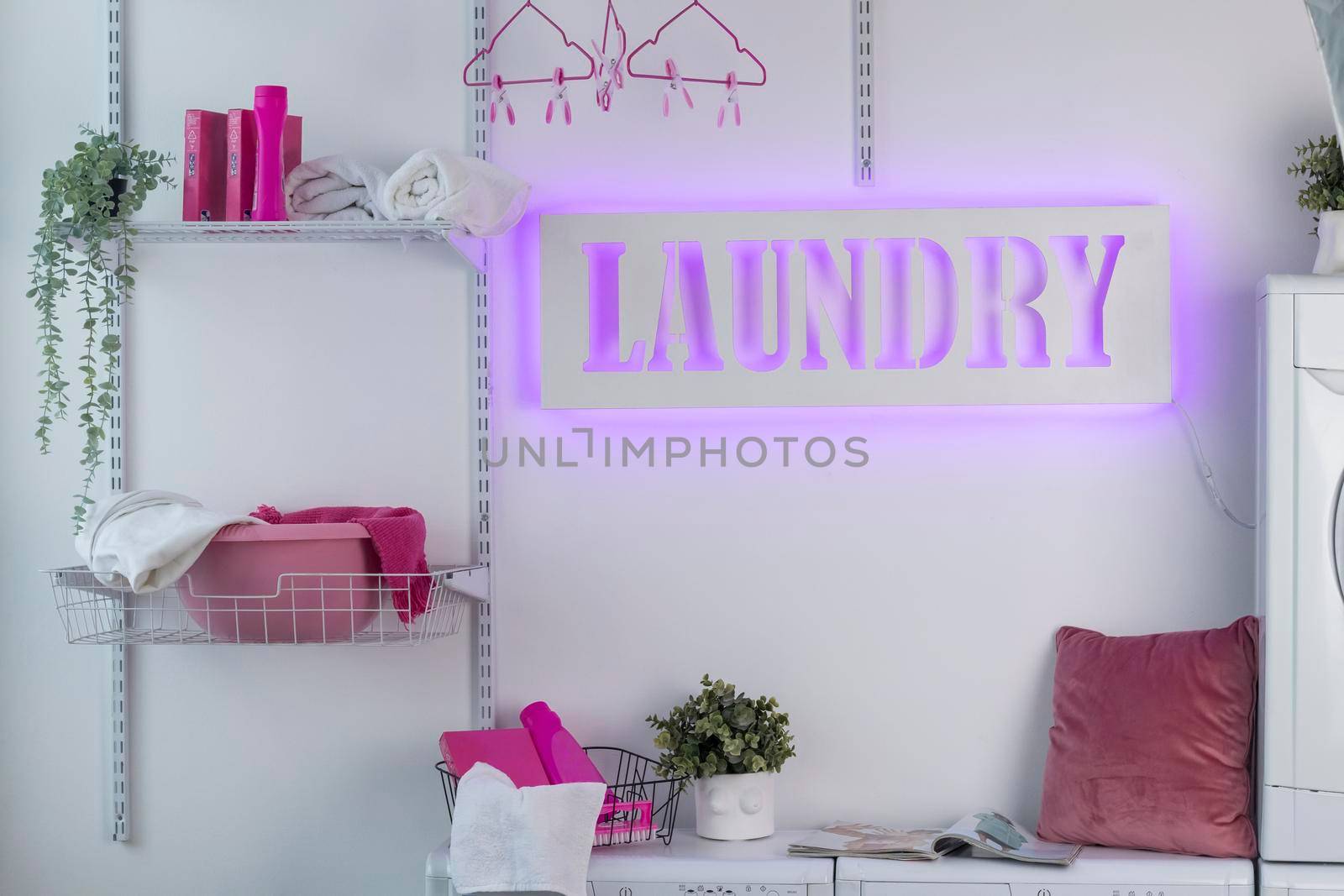 Glowing neon laundry sign on a white background. Illuminated signboard self-service laundry by Hitachin