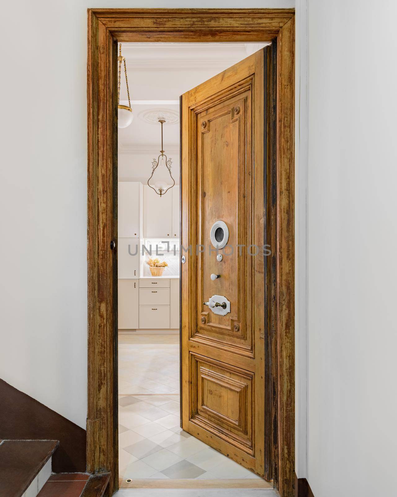 Typical wooden door in a building of old town of Barcelona, Spain. Entrance with opened door to refurbished apartment. by apavlin