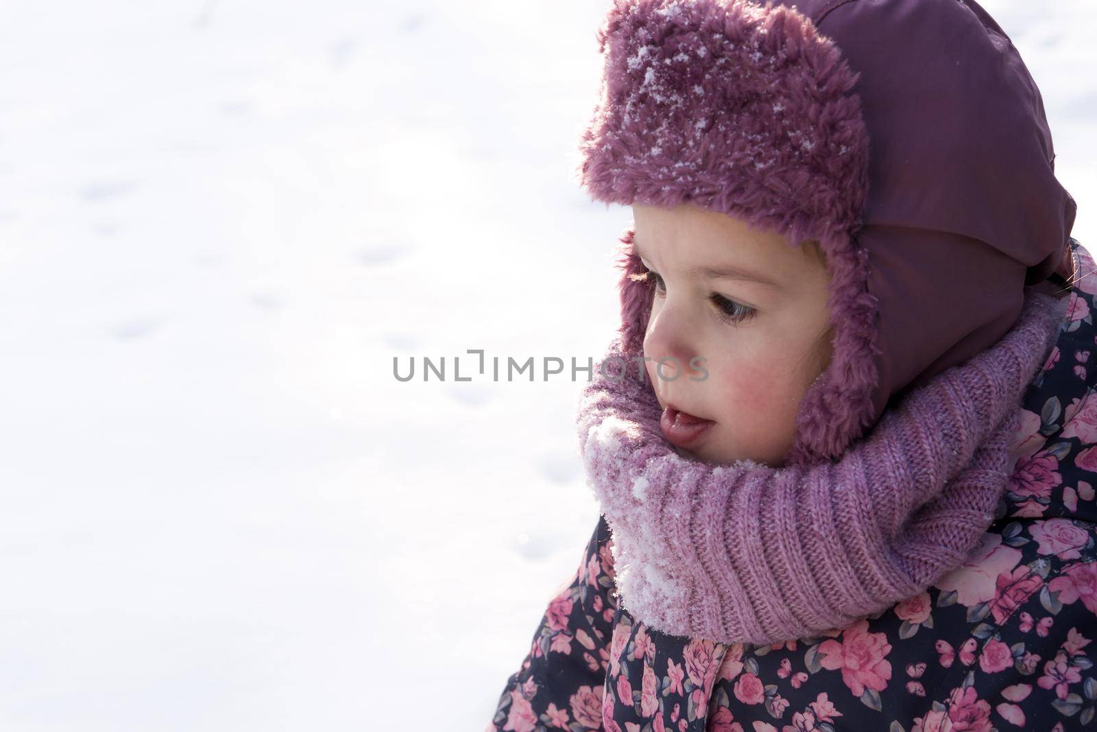 Winter, family, childhood concepts - close-up portrait authentic little preschool minor baby girl in pink warm clothes walking in snowy frosty weather day. happy pretty cute kid face have fun outdoors.