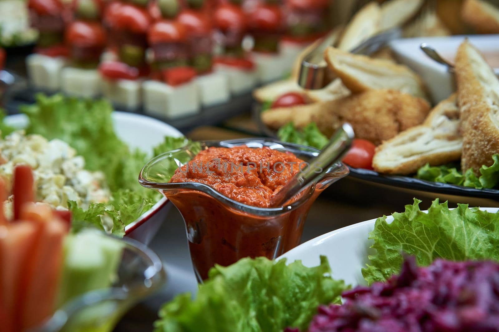 Aivar sauce in the background with another meal on the table closeup