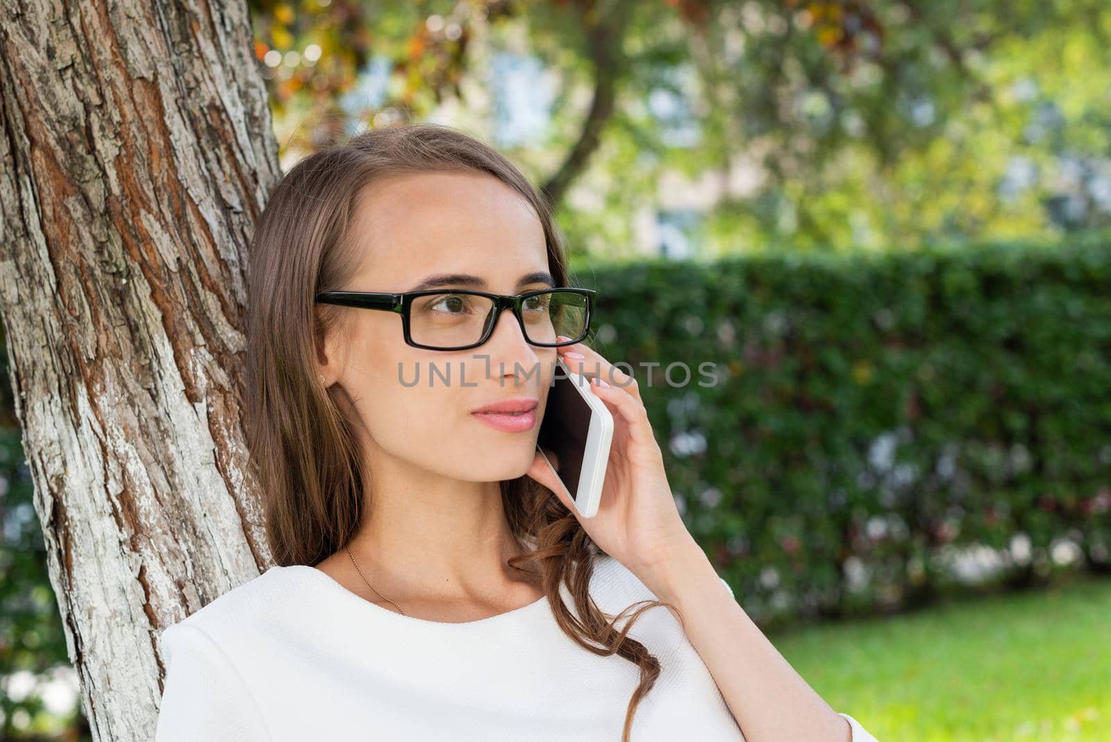 A portrait of a smiling beautiful woman talking on the phone