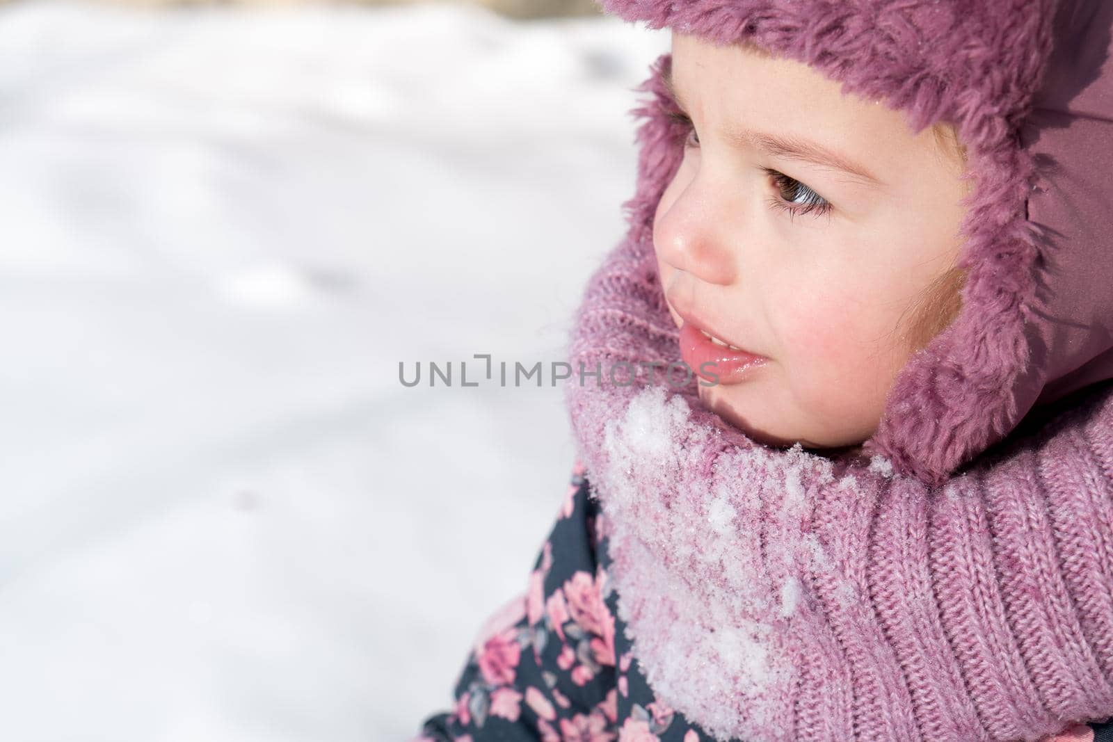 Winter, family, childhood concepts - close-up portrait authentic little preschool minor 3-4 years girl in pink hat look at camera posing smile in snowy frosty weather. happy kid face have fun outdoors.