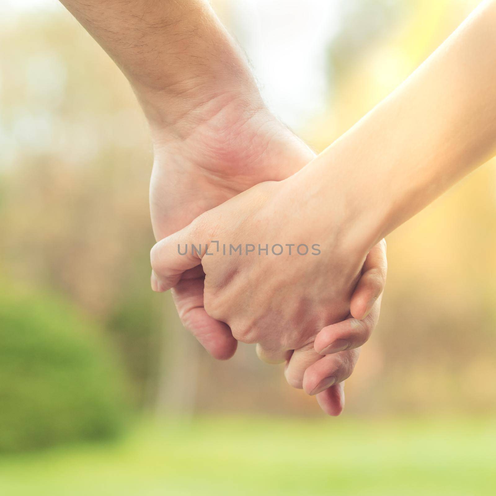 Two hands together, a man and a woman holding hands. Husband and wife together. Support and understanding by NataBene