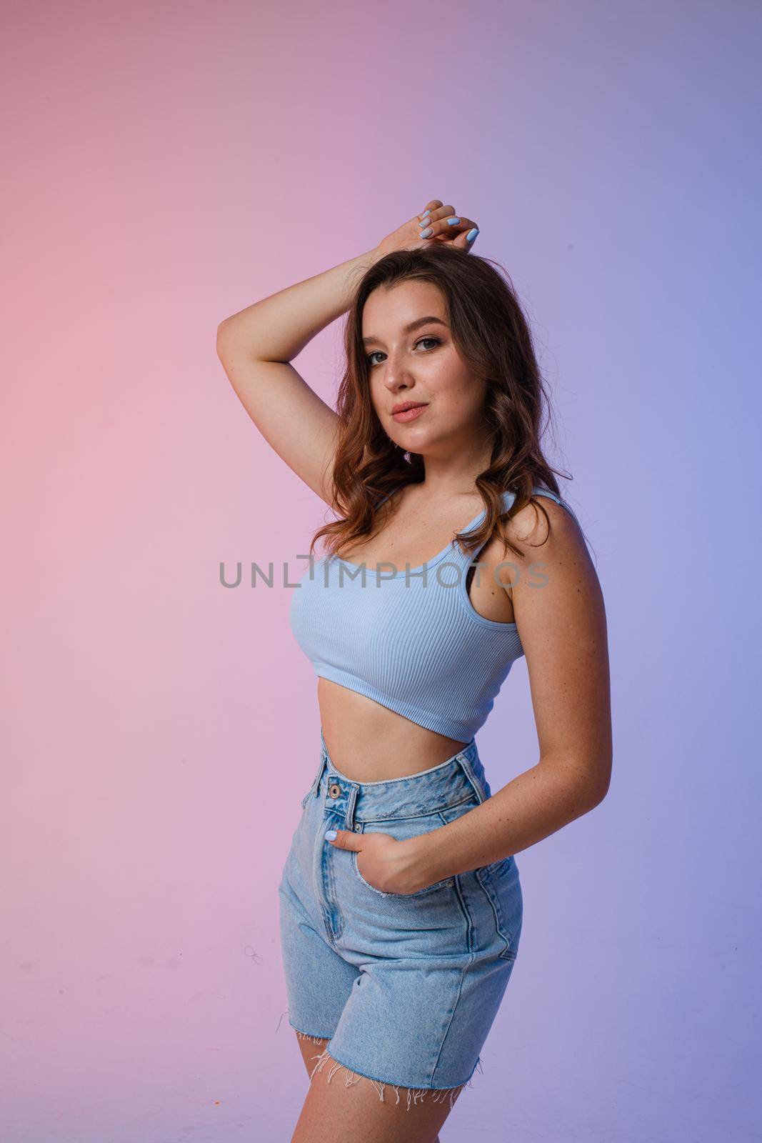 a woman in denim shorts, sunglasses in the studio on an interesting beautiful background by StudioLucky