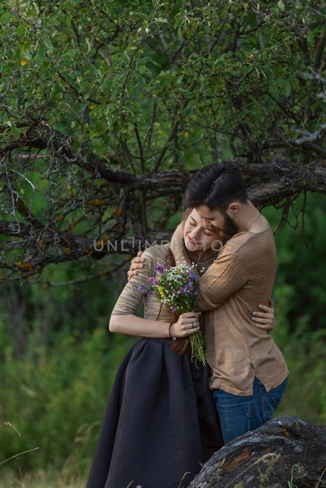 couple hugging near a tree by zokov