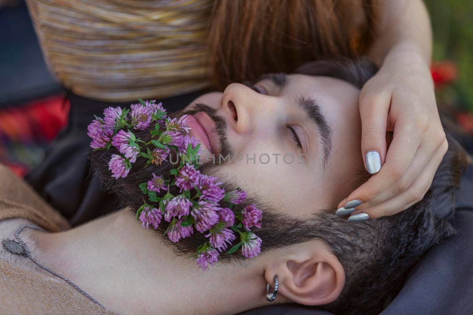 man with flowers in his beard