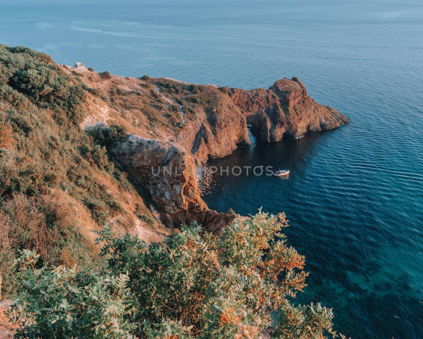 View of Cape Fiolent, Crimea, Sevastopol. Spring sunny day, flowering yellow bush. The concept of calm, silence and unity with nature. by Matiunina