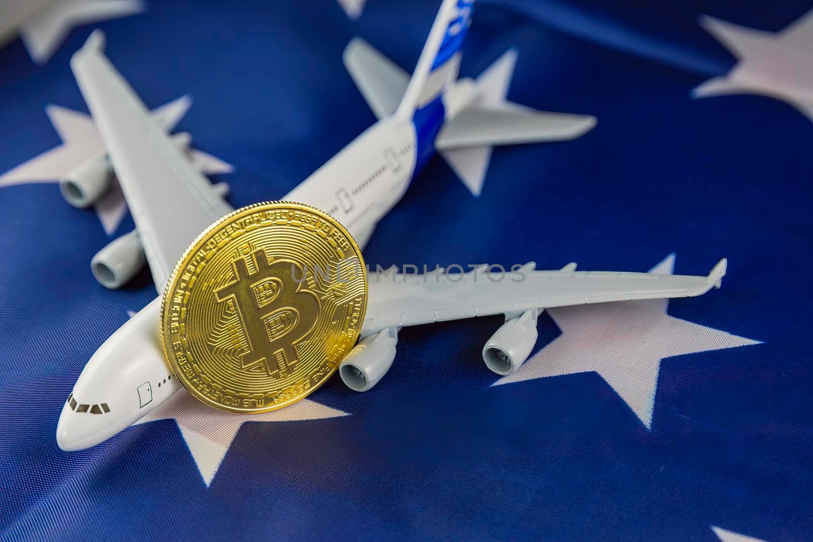 airplane and bitcoin coins on american flag