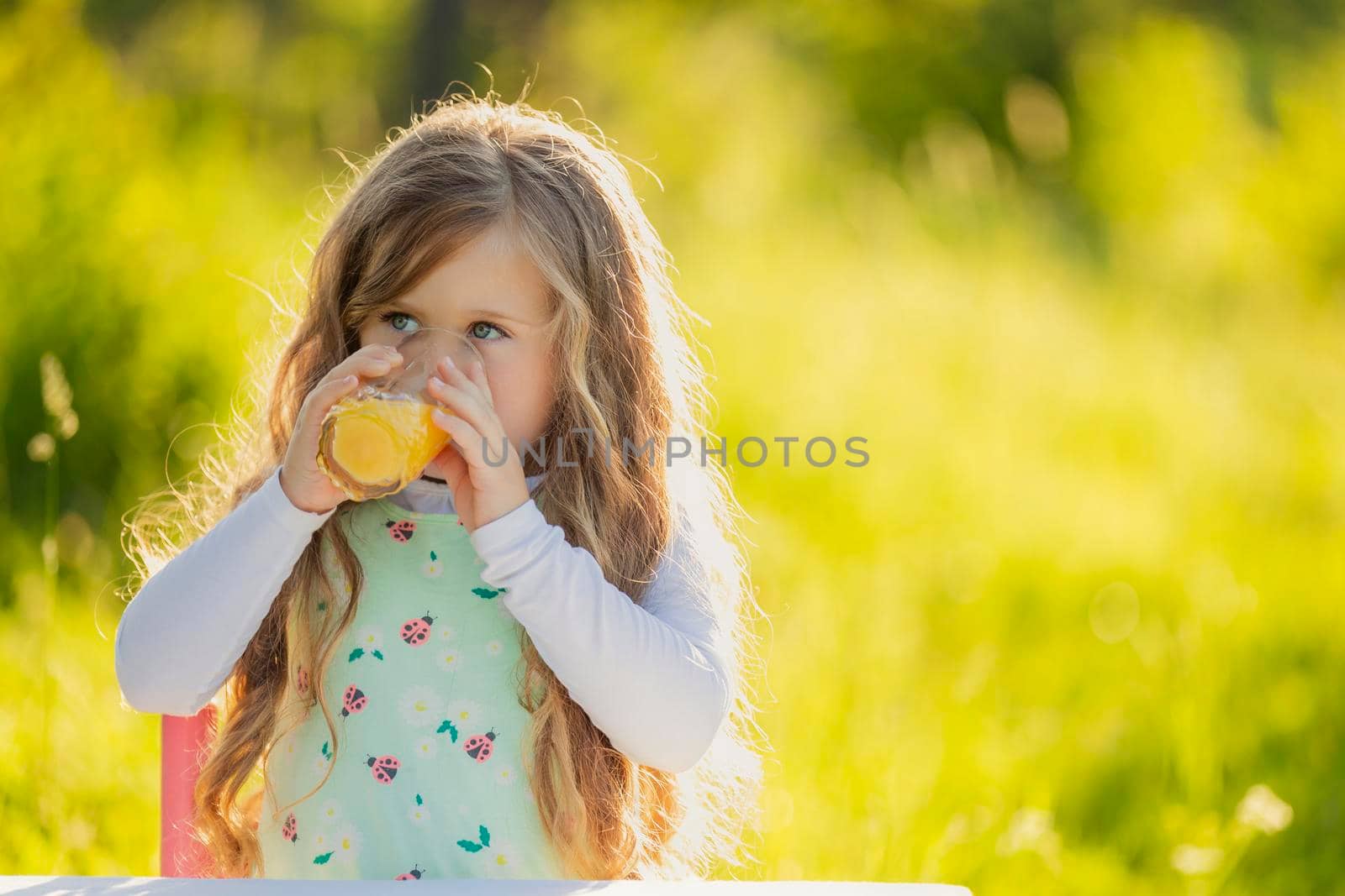 child drinking orange juice by zokov