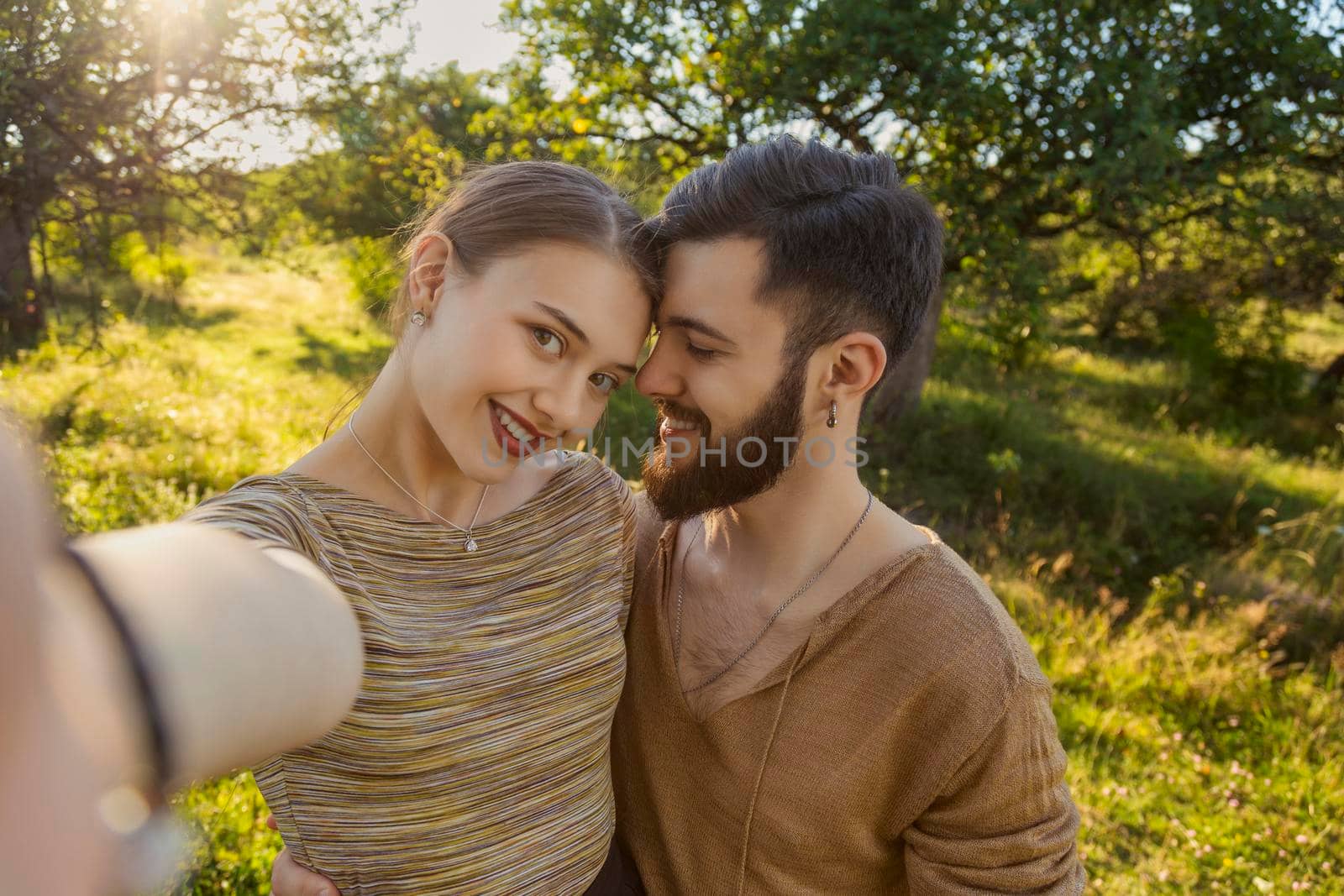 portrait of a couple taking a selfie by zokov