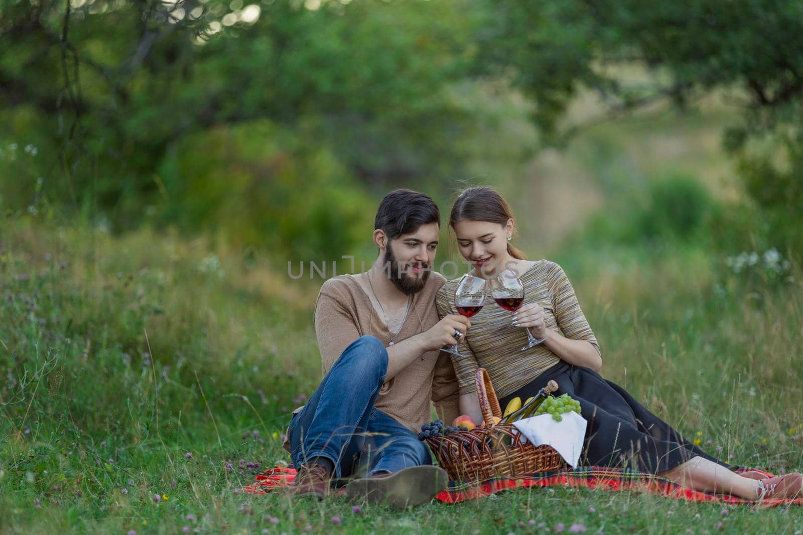 couple drinking wine in nature by zokov