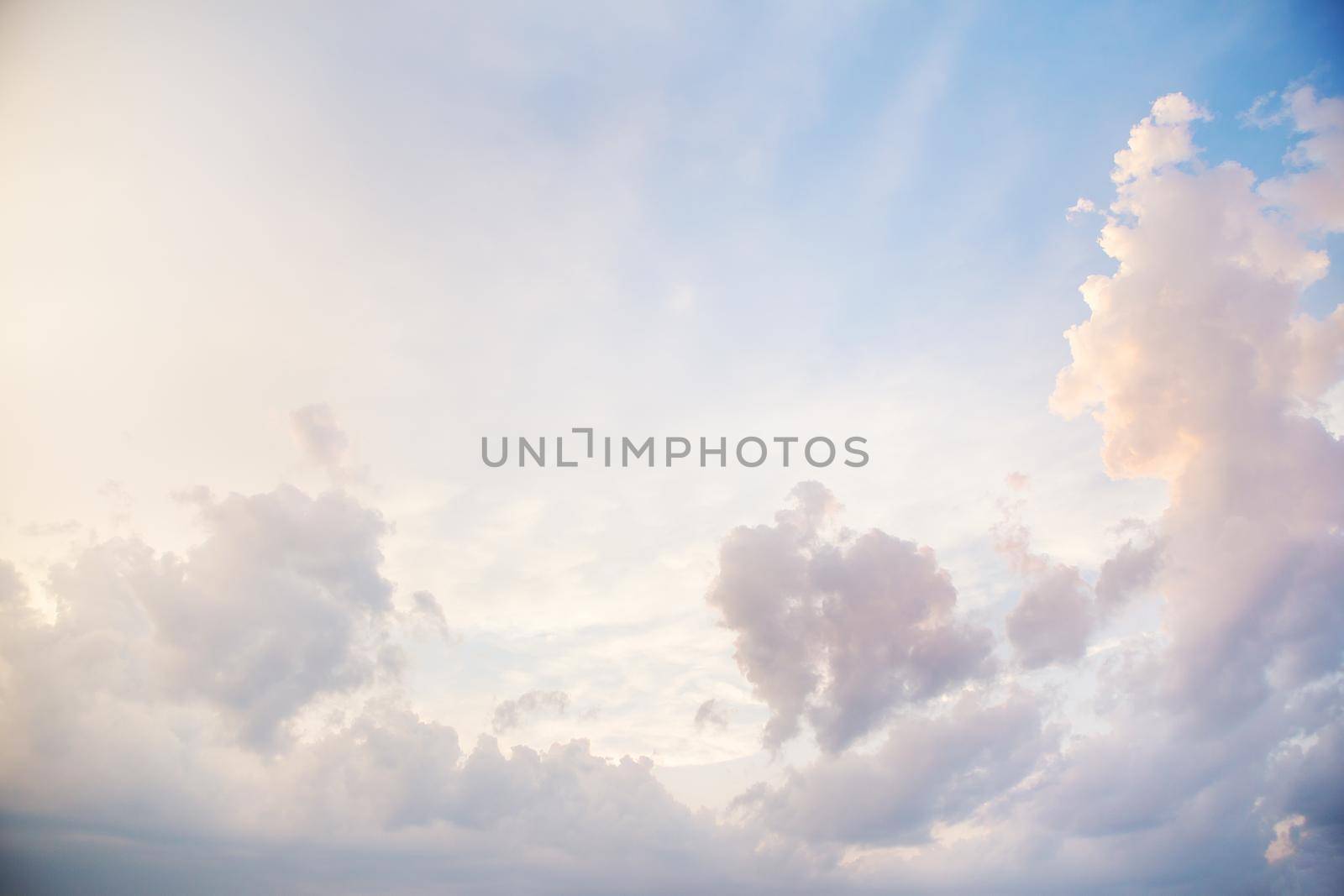 blue sky with a big cloud coating with orange sunset light by sfinks