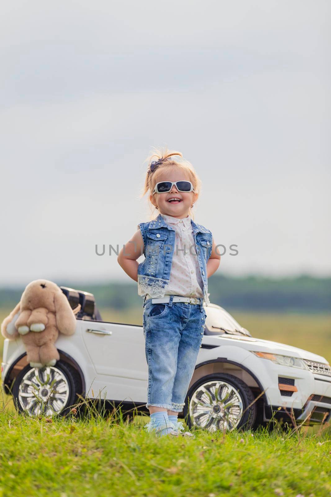 girl in sunglasses stands in front of a car by zokov