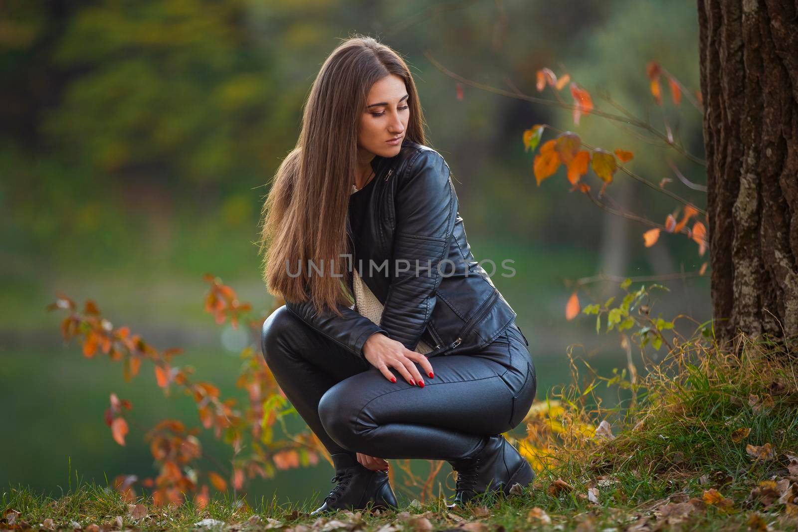 girl in black leather clothes near the tree