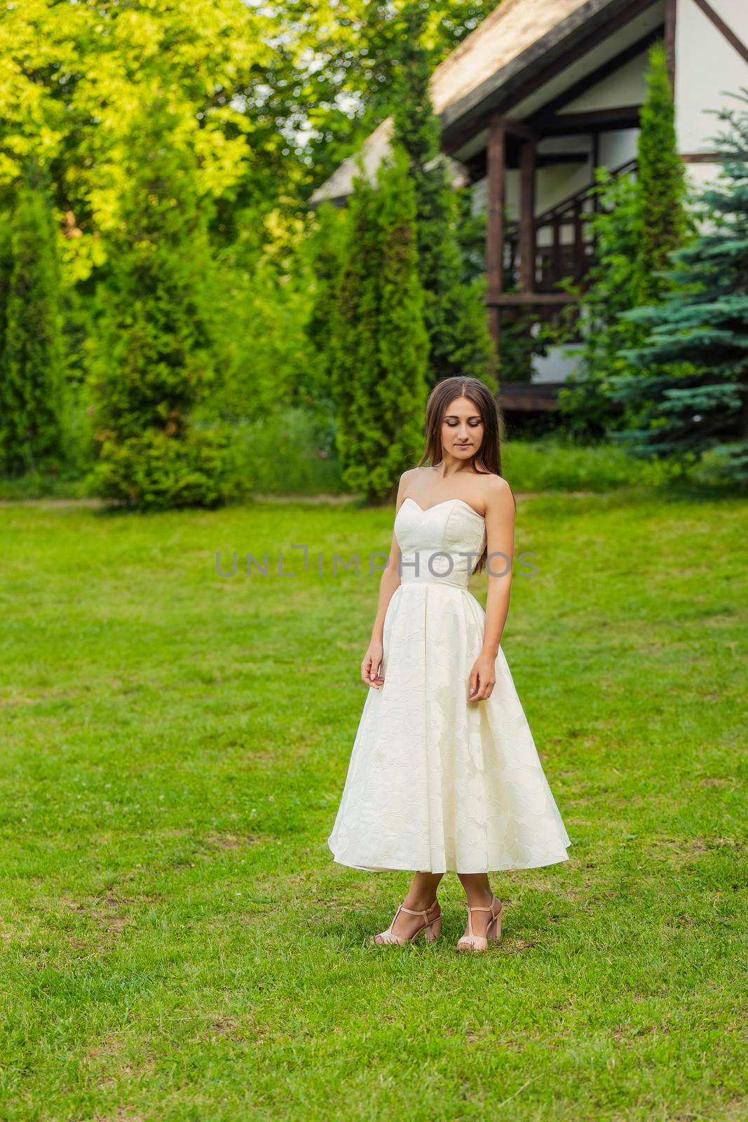 woman in a white dress on a green lawn