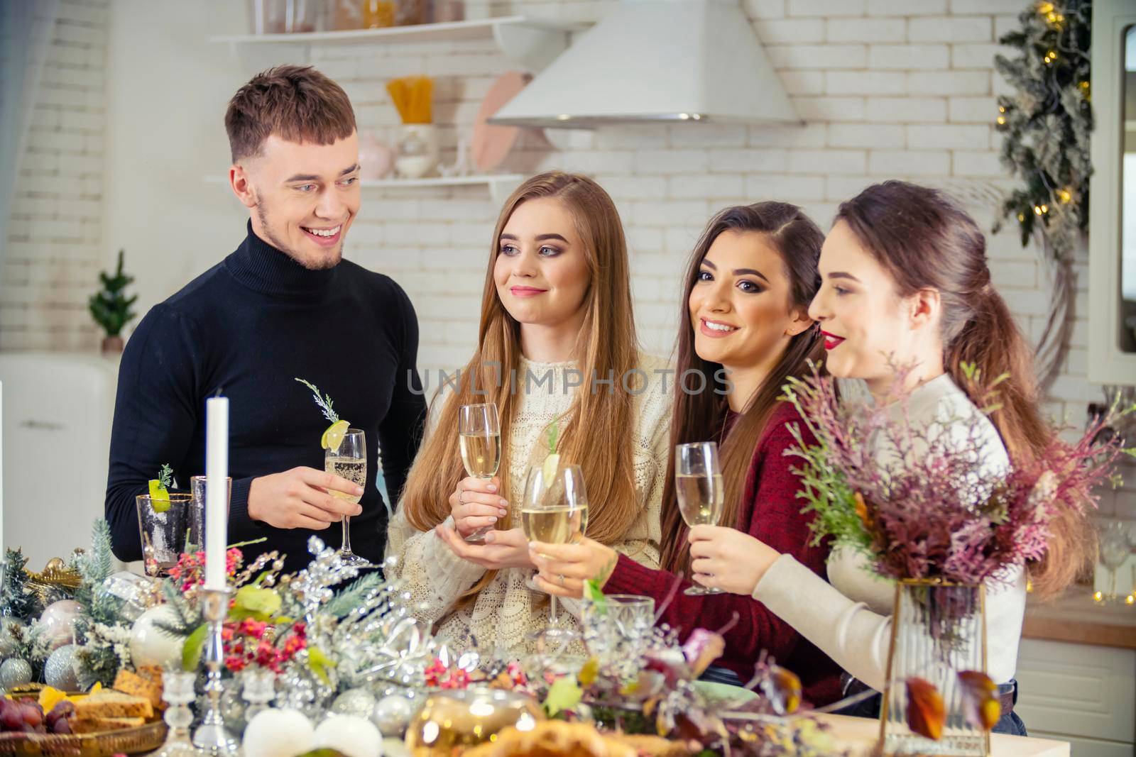 guy with girls drinking champagne standing at the table