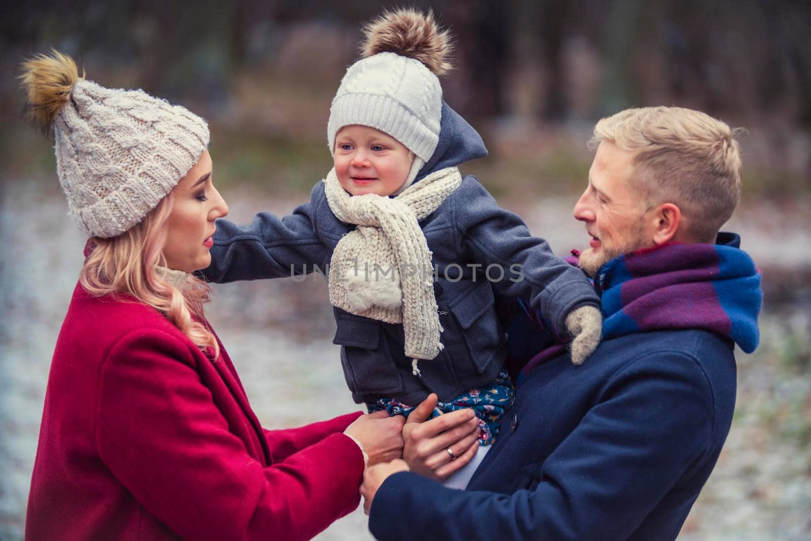 young family walking in the park in winter by zokov