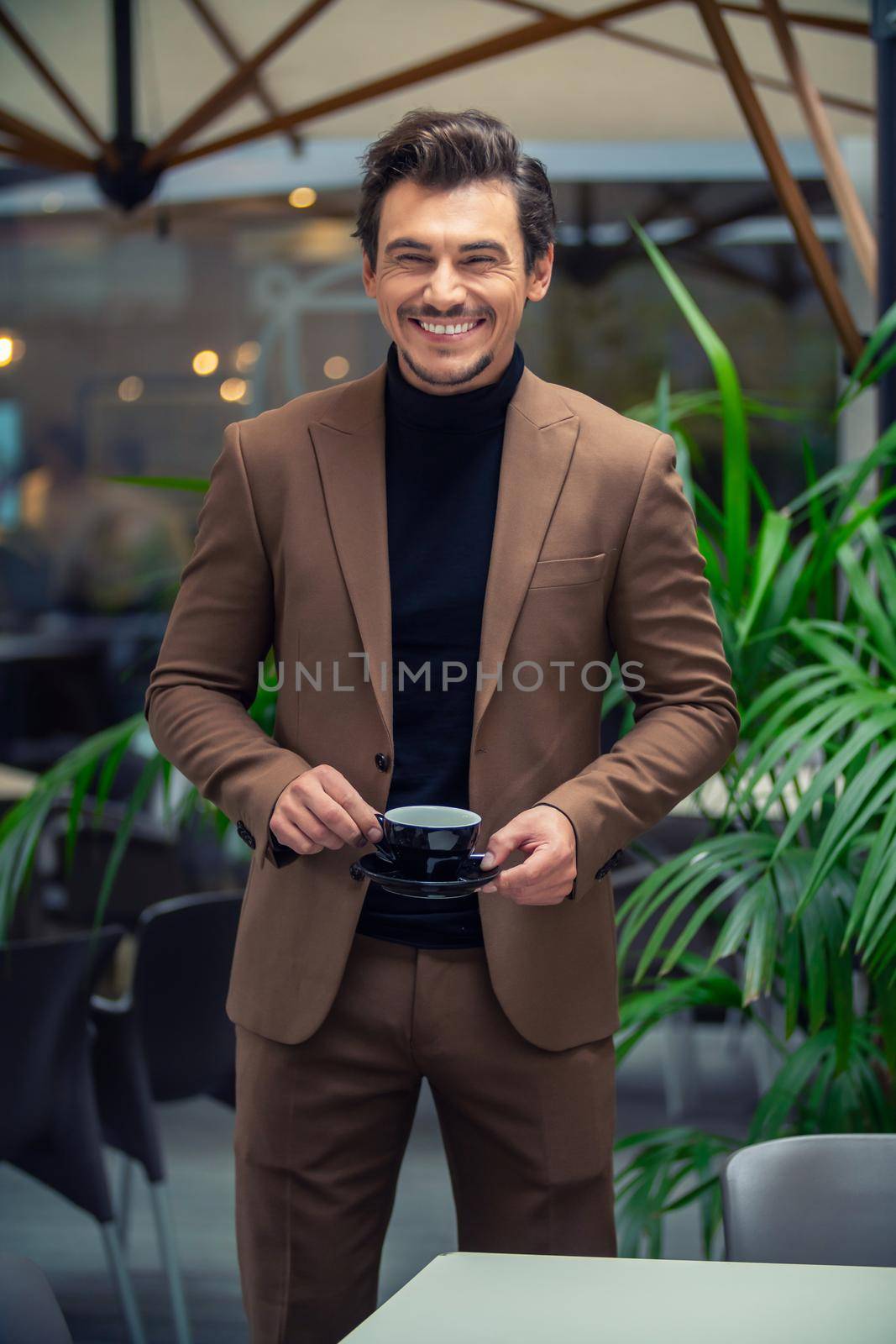 a man in a business suit drinking tea by zokov