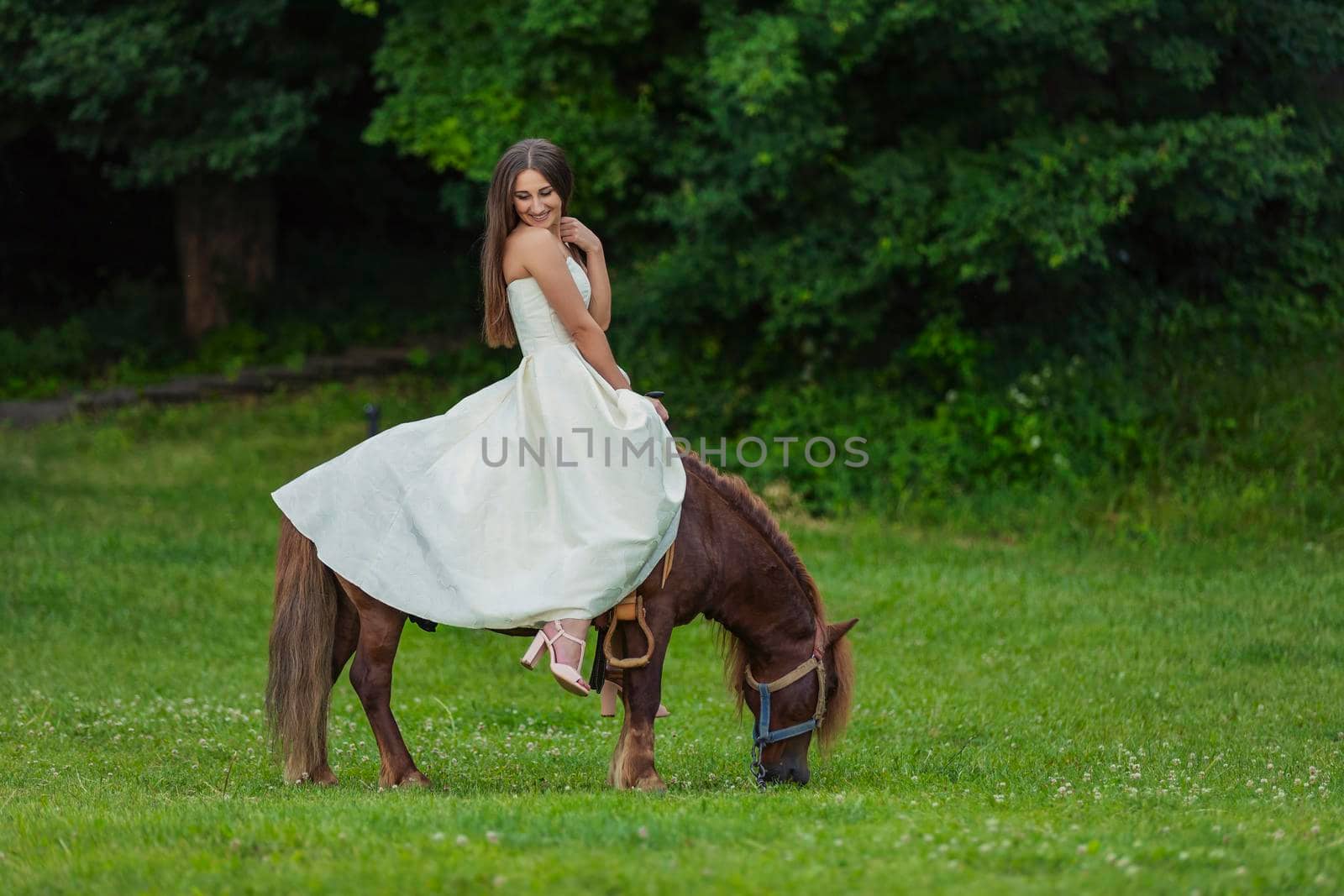 girl riding a pony in the park