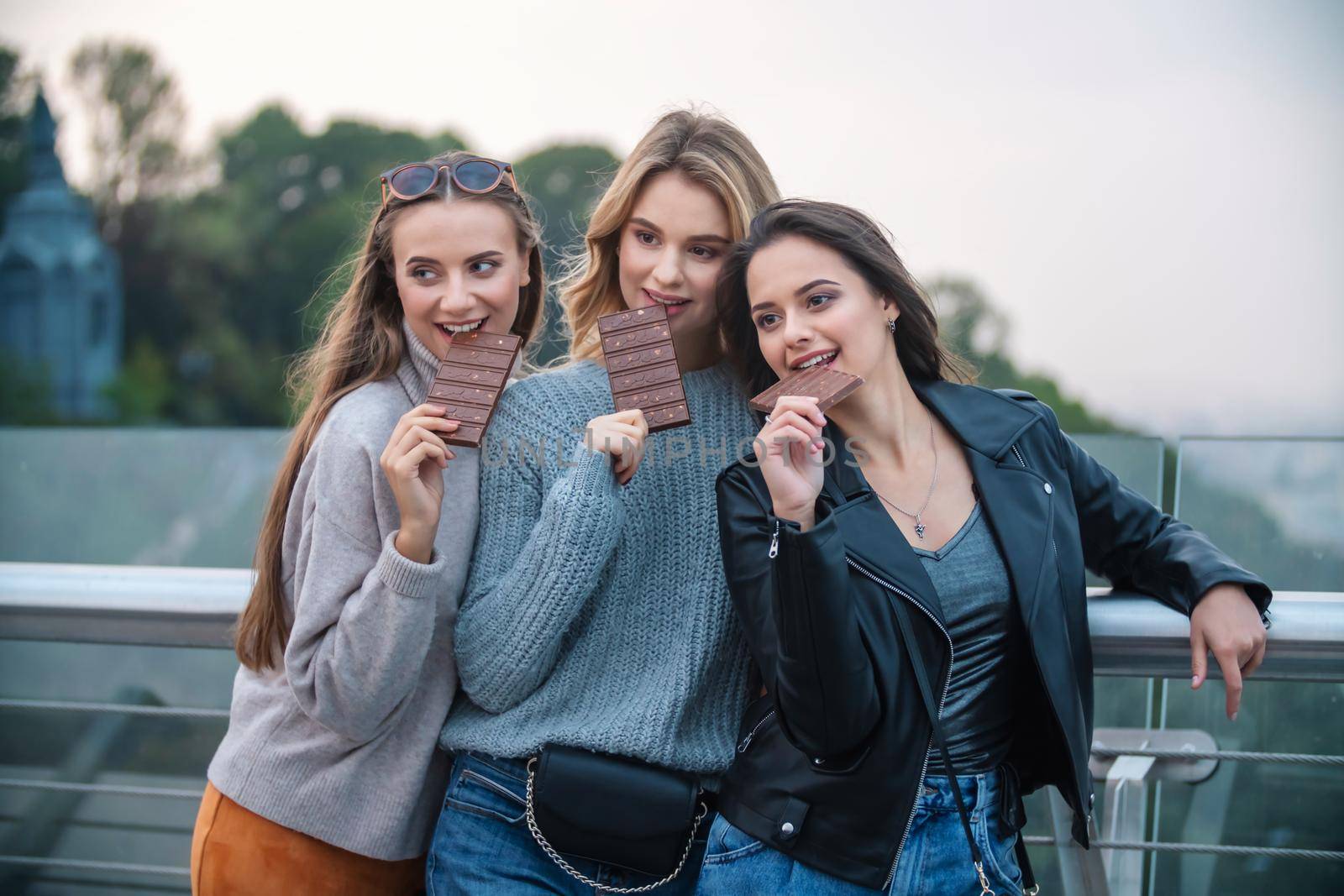 three girls eating chocolate with nuts